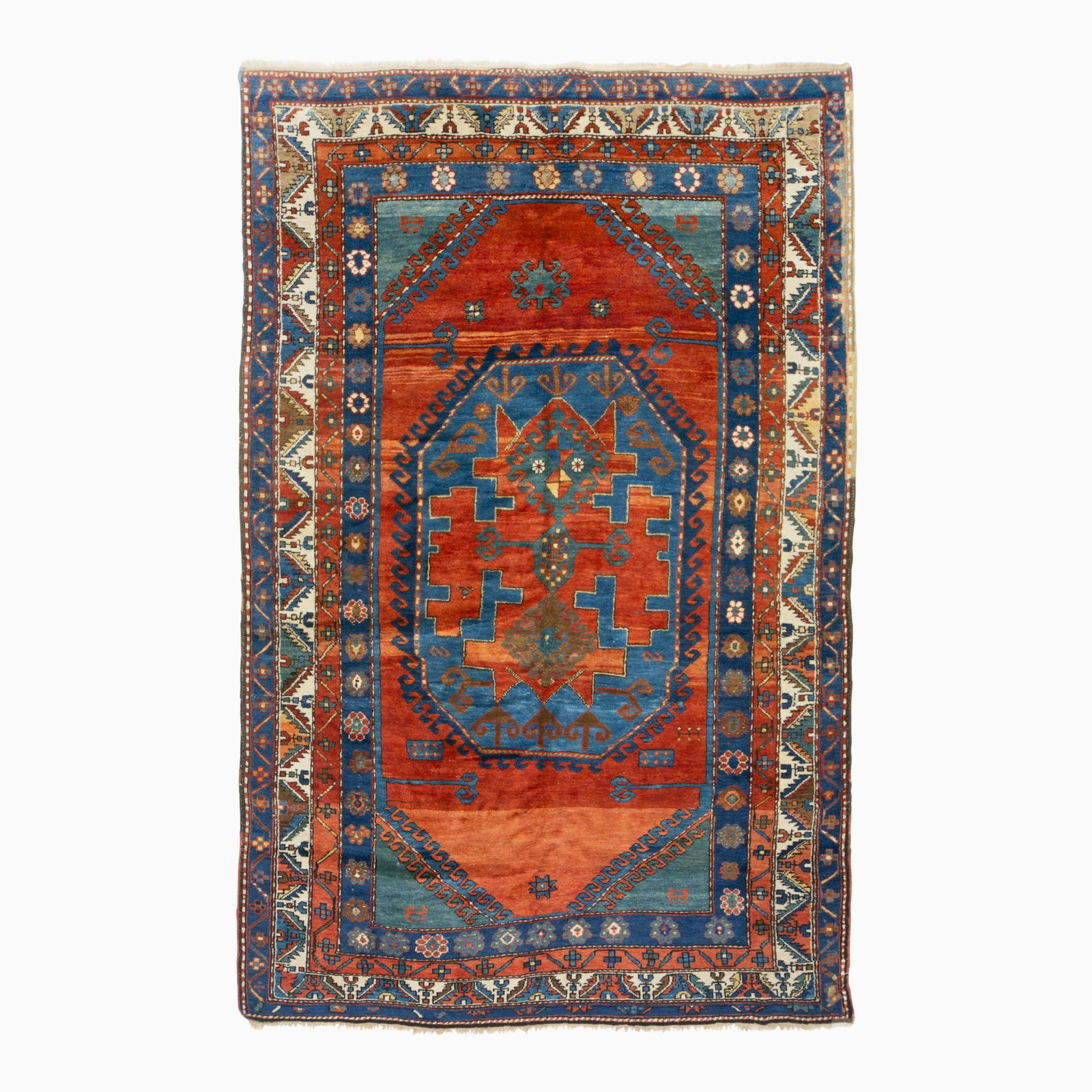 Lori Pambak Kazak Rug: Southwest Caucasus, early 20th century The abrashed madder field with a central octagonal latch hook medallion flanked by slate-blue spandrels is within an ivory serrated leaf and calyx border. 7