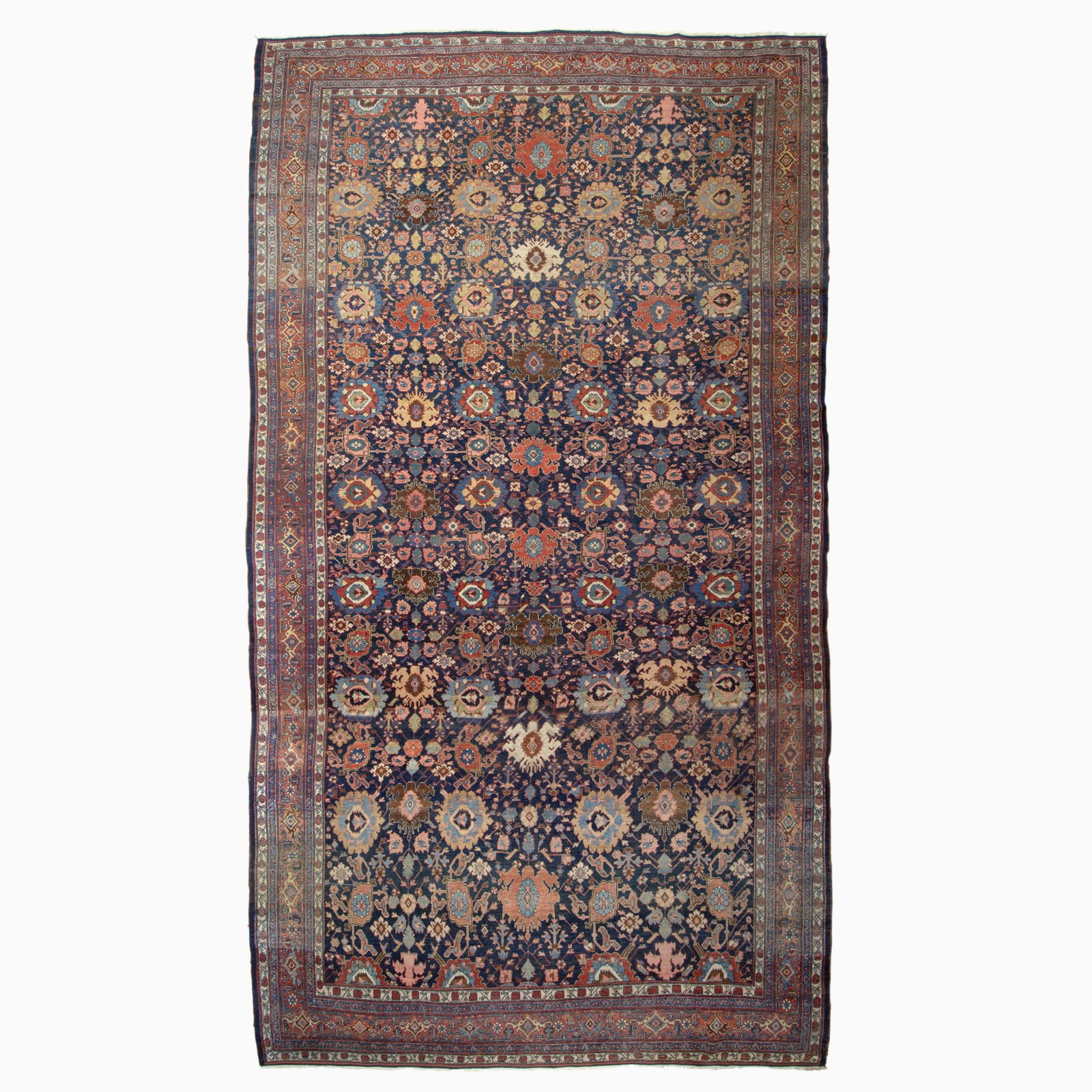 Bidjar Carpet: North Persia, Late 19th Century The indigo field with a polychrome Harshang pattern overall is within a madder palmette and vine border. Wool foundation. 18 feet 7 inches x 11 feet 0 inches. Provenanc