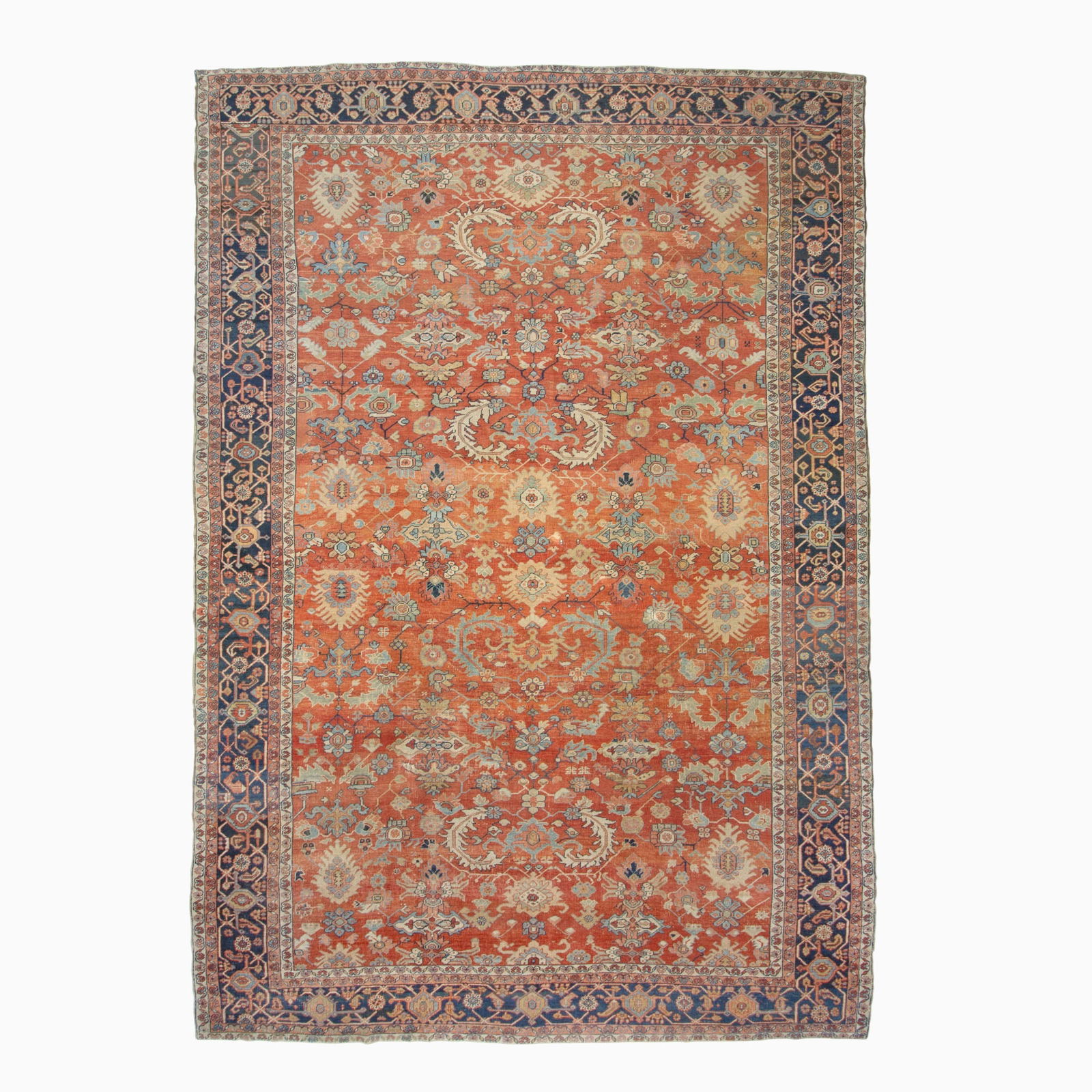 Heriz Carpet: Northwest Persia, Late 19th Century The overall pattern of stylized floral vinery on the madder field is within an indigo palmette and vine border. 16 feet 1 inch x 10 feet 11 inches. Provenance: Symo