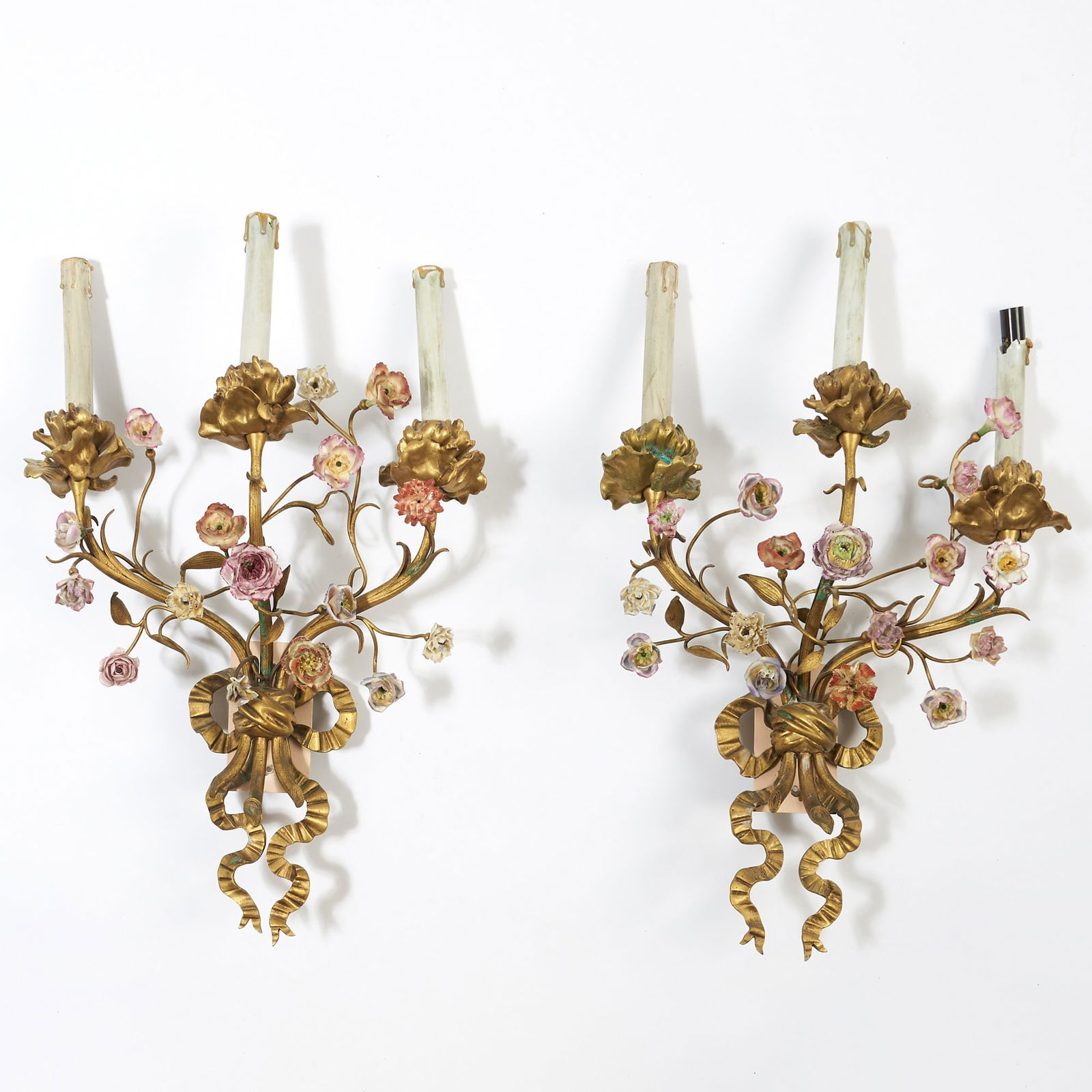 Pair of Louis XVI Style Porcelain Flower Encrusted Gilt Bronze Three-Branch Wall Lights: Late 19th century Height 17 1/2 inches (44.5 cm), width 14 inches (35.5 cm), depth 5 1/2 inches (14 cm).