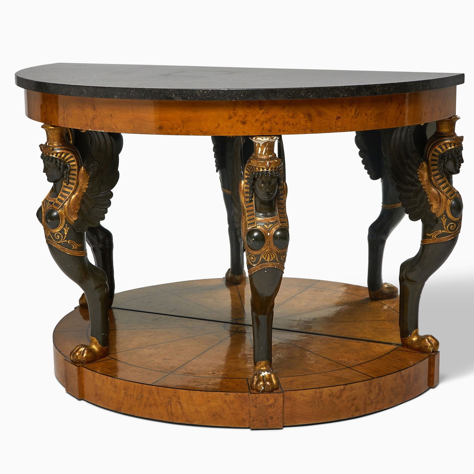 Baltic Neoclassical Gilt and Painted Karelian Birchwood Demilune Console: Early 19th century The demilune black marble top above a conforming frieze resting on winged monopodia and plinth. Height 37 1/4 inches (94.5 cm), width 55 inches (140 cm), dept 28 1/4 inches (71.5 cm