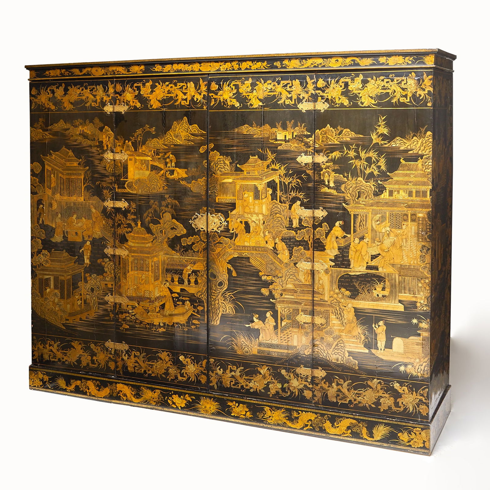 Large Chinese Gold and Black Lacquer Cabinet: Incorporating 18th century elements Of six panels depicting Chinoiserie decoration of landscapes, pagodas and figural scenes inclosing a fitted interior, on plinth. Height 82 1/4 (209 cm), width 96 (2