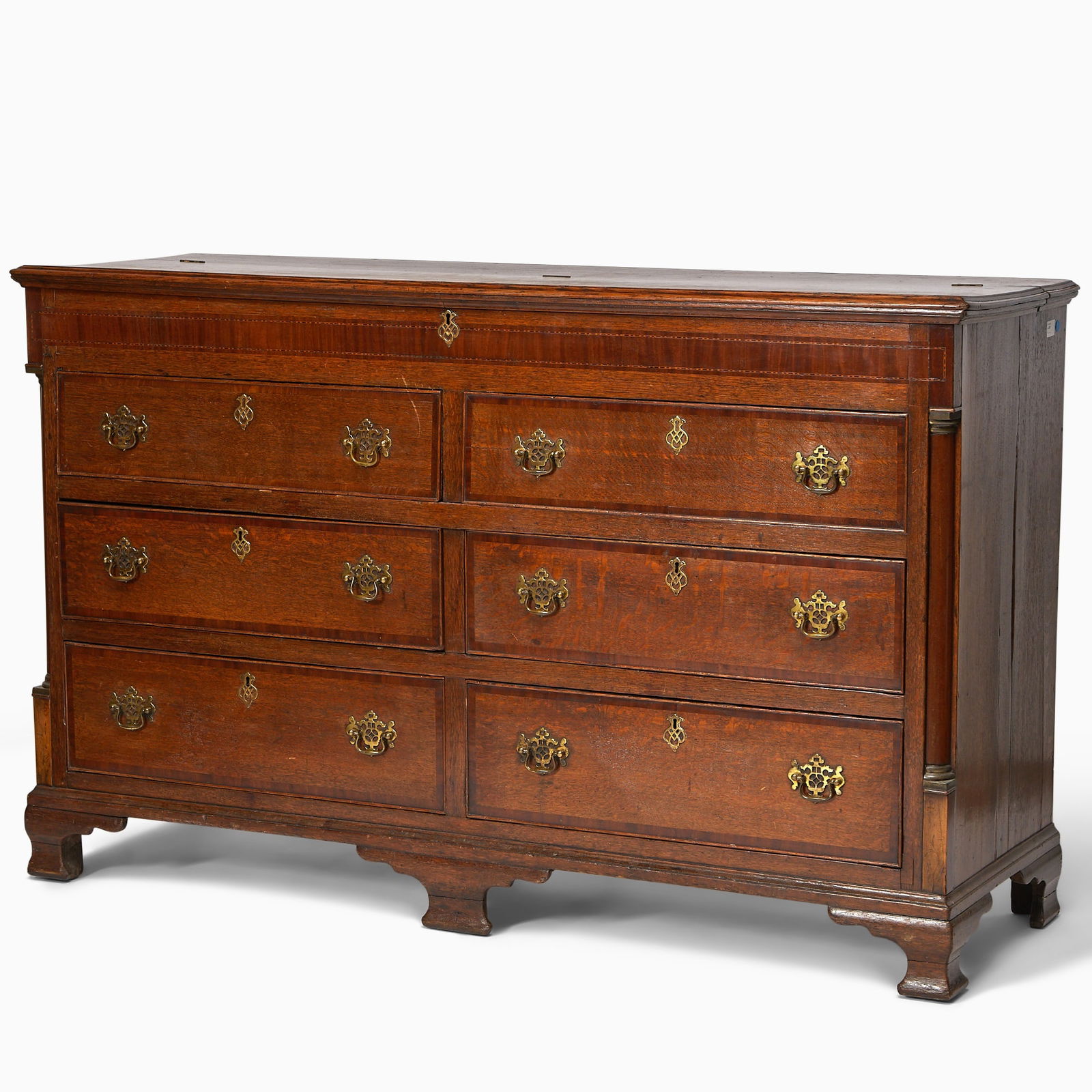 George III Provincial Mahogany Inlaid Oak Double Chest of Drawers: Last quarter, 18th century The molded hinged rectangular top above a banded and line-inlaid frieze and two false drawers over four long drawers flanked by pilasters on shaped bracket feet. Height 42 1