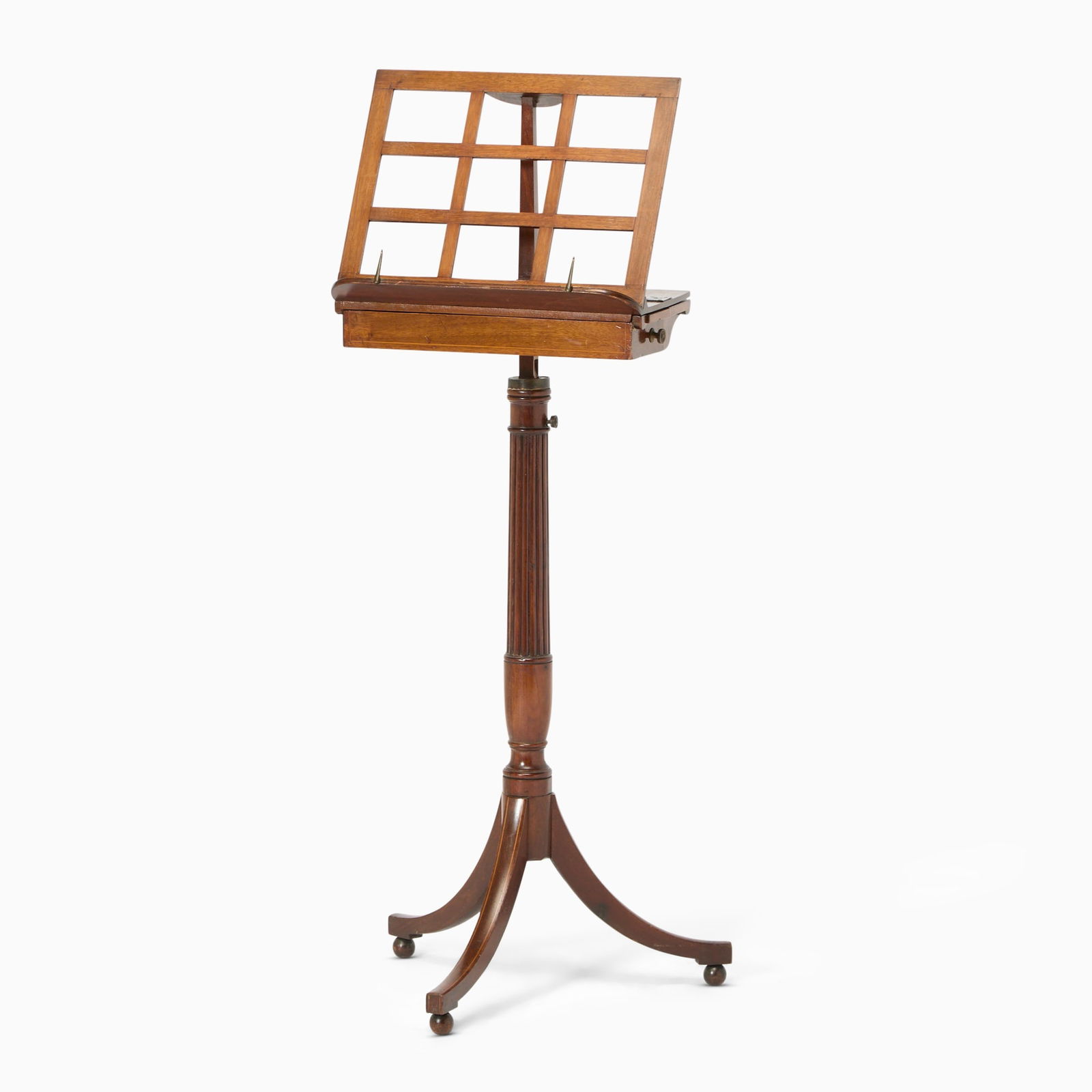 Regency Fruitwood Inlaid Mahogany Music Stand: First quarter 19th centuryThe pierced music slope above two candle slids and a secret drawer on a racheted reeded support and tripod base, on ball feet.Height 45 1/2 inches (115.5 cm), width 17