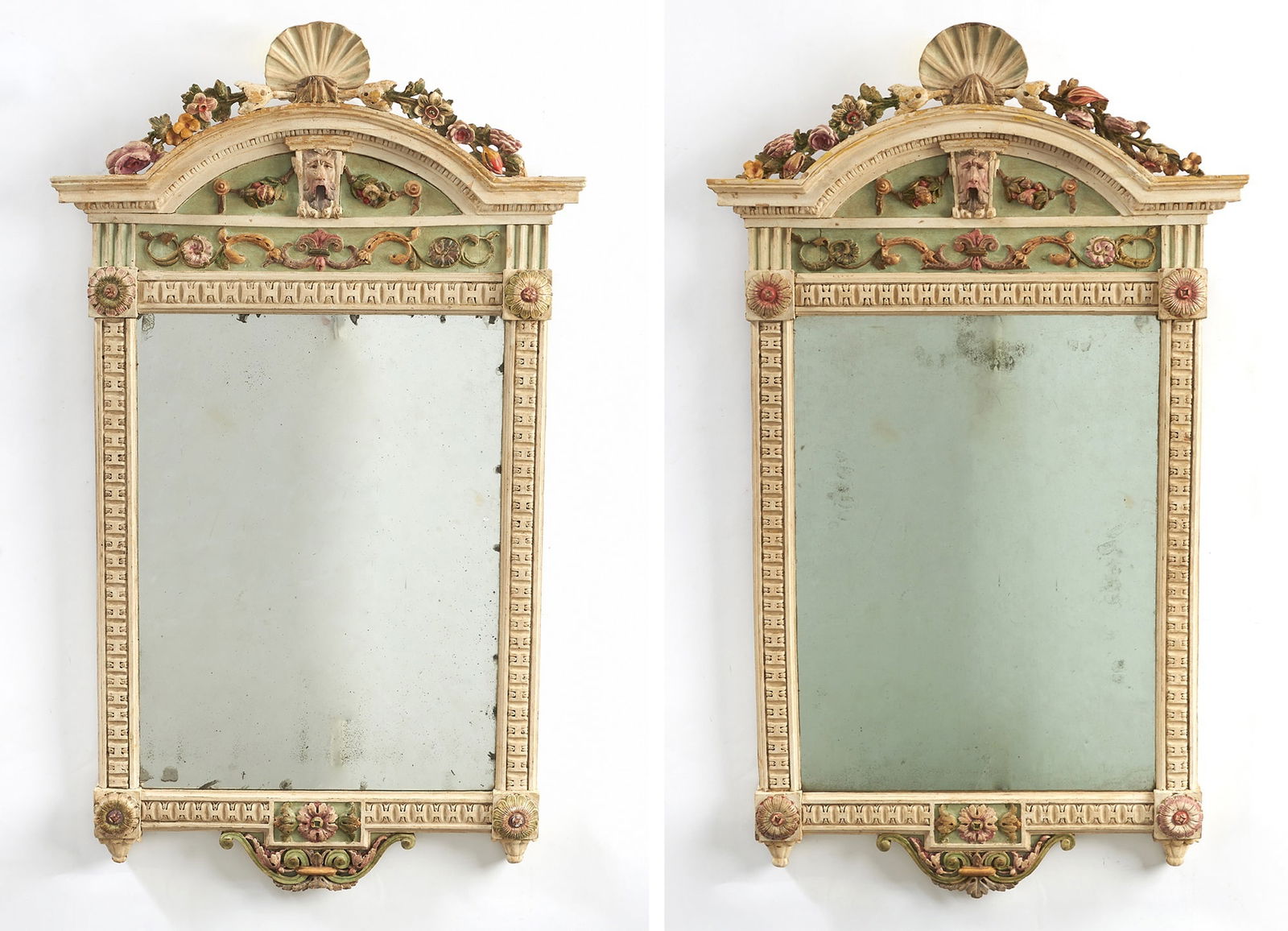 Pair of North Italian Polychrome Painted Wood Mirrors: In the manner of Michelangelo Pergolesi, (1760-1801), last quarter 18th CenturyEach arched pediment centered by a shell and floral cresting above a scroll-carved cresting centered by a mask and