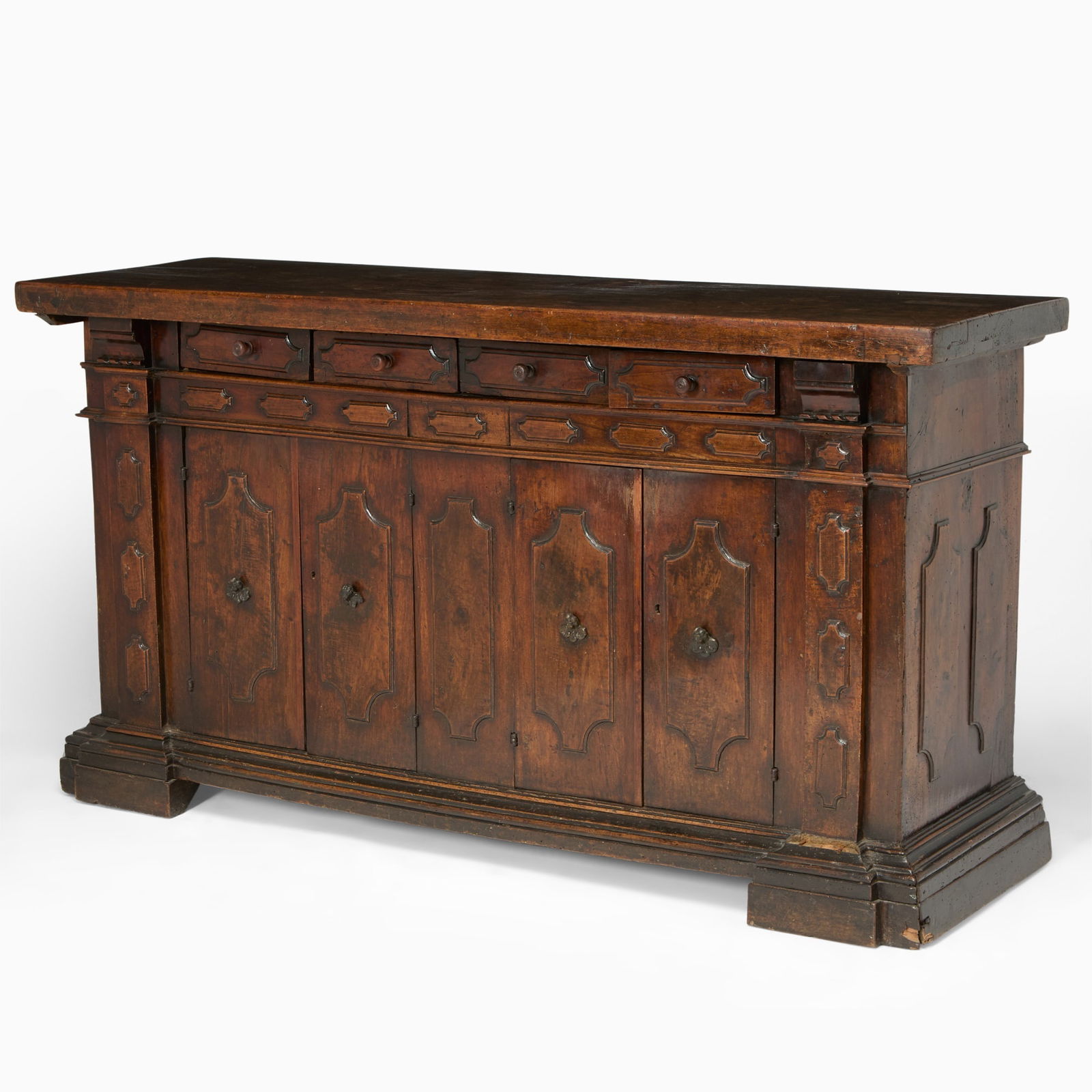 Bolognese Walnut Side Cabinet: 19th century and laterThe molded rectangular top above four frieze drawers and four cupboard doors with raised molded cartouche panels throughout on a plinth, with cherub form bronze pulls.Height 45