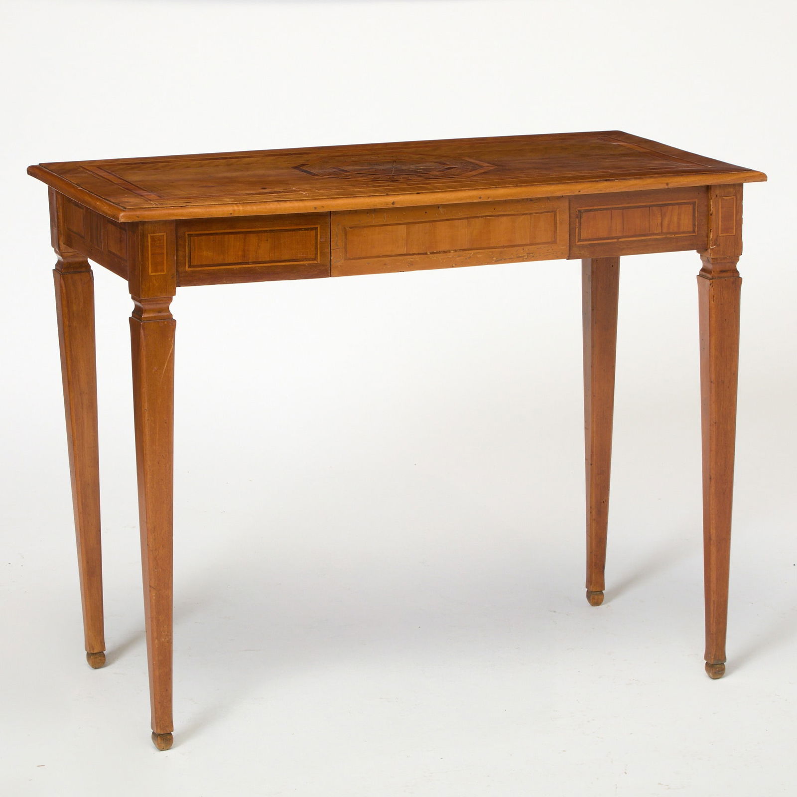 Continental Parquetry Inlaid Fruitwood Side Table: 19th century, probably ItalianThe molded rectangular top with radiating wheat sprigs within a concentric hexagonal border above a frieze drawer, on tapering square legs.Height 29 1/4 inches (74.2