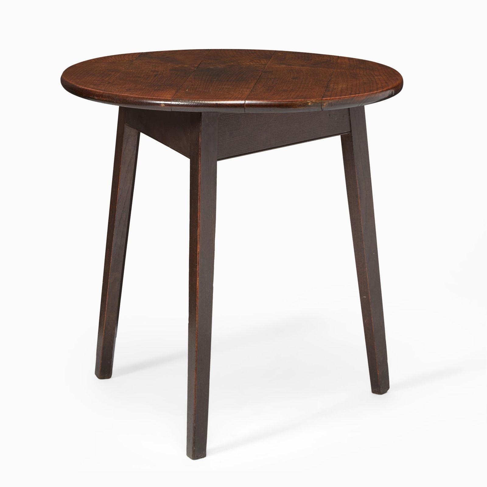 Victorian Walnut Center Table: Late 19th/early 20th centuryThe rounded panel top above a plain frieze on angled legs.Height 29 1/2 inches (74.3 cm), diameter 28 3/4 inches (73 cm). Shrinkage cracks to the top, stains, scratches,