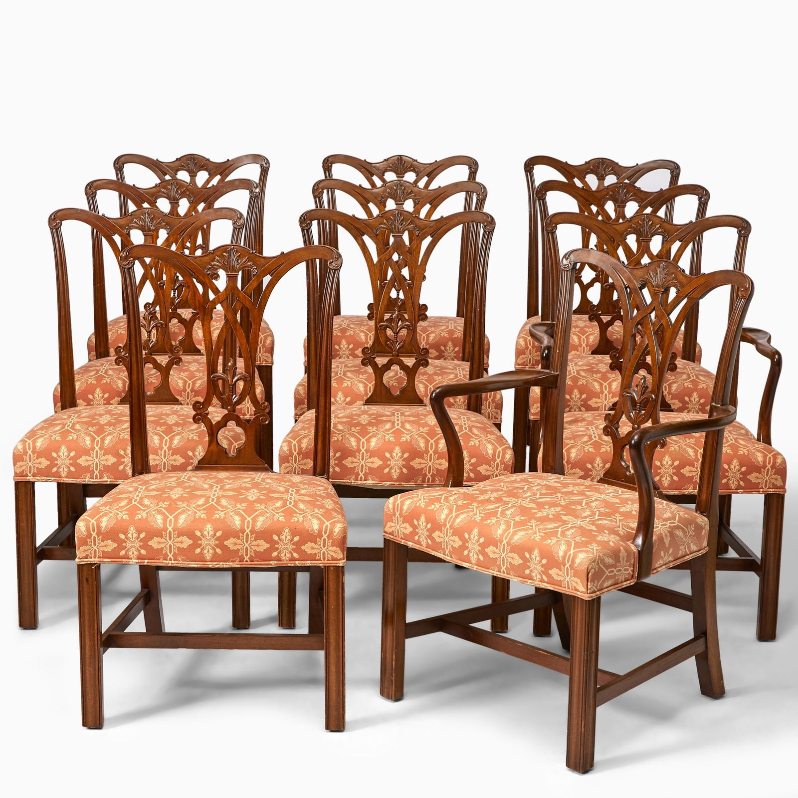 Set of Eleven George III Style Mahogany Dining Chairs: 20th centuryComprising two armchairs and nine side chairs, each carved and molded yolk crestrail above a pierced splat, shaped arms over a serpentine seat, on molded chamfer legs joined by
