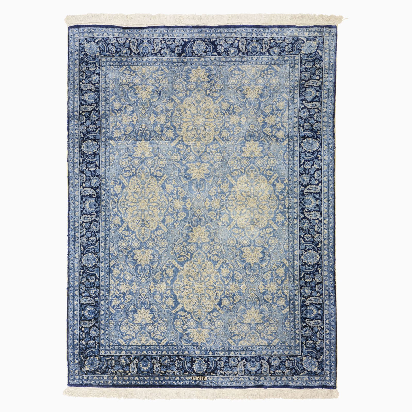 Hereke Silk Rug: West Turkey, ContemporaryThe sky-blue field with an overall pattern of floral medallions is within an indigo palmette, curled leaf, and boteh border. Signed "Iznik". 361 kpsi.5 feet 5 inches x 3 feet