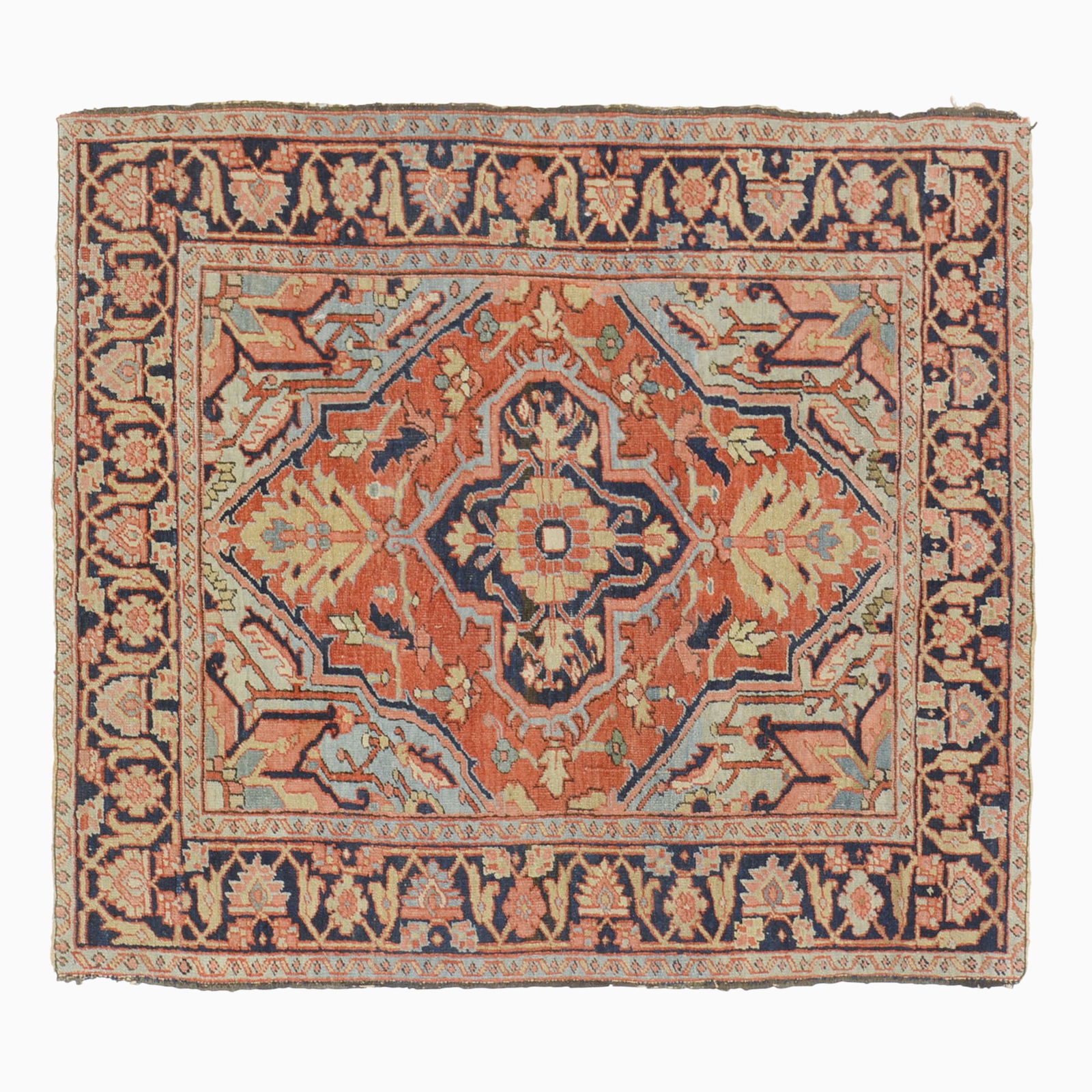 Heriz Rug: Northwest Persia, Circa 1920The madder field with a central geometric medallion flanked by sky-blue spandrels is within an indigo palmette and vine border.4 feet 7 inches x 4 feet 2 inches. Partial