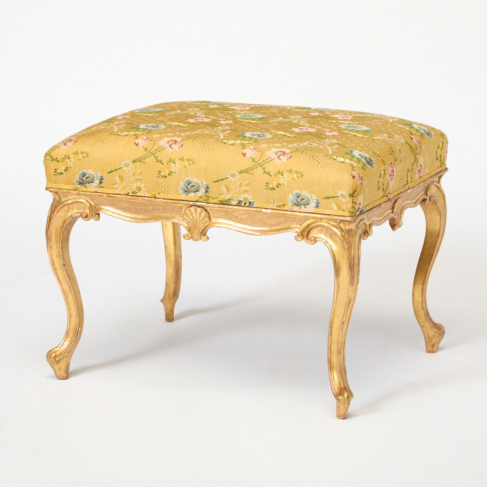 George III Giltwood Bench: Circa 1790, in the French styleThe rectangular yellow silk floral damask upholstered seat over a lattice-molded frieze centered by shell pendants, on cabriole legs.Height 18 inches (45.7 cm), width