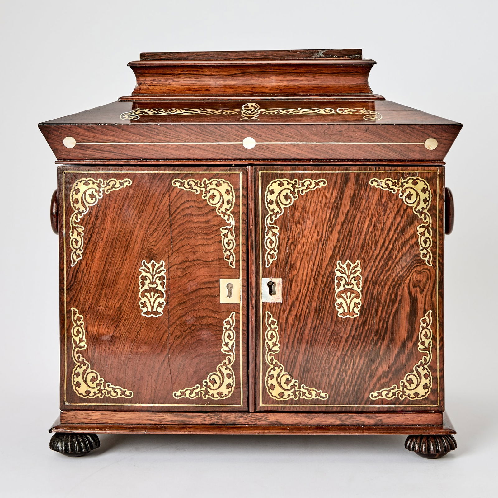 Regency Brass and Mother-of-Pearl Inlaid Rosewood Jewelry Cabinet: In the manner of George Bullock, circa 1820 Height 12 3/4 inches (32.5), width 13 inches (33 cm), depth 10 inches (25.5 cm).