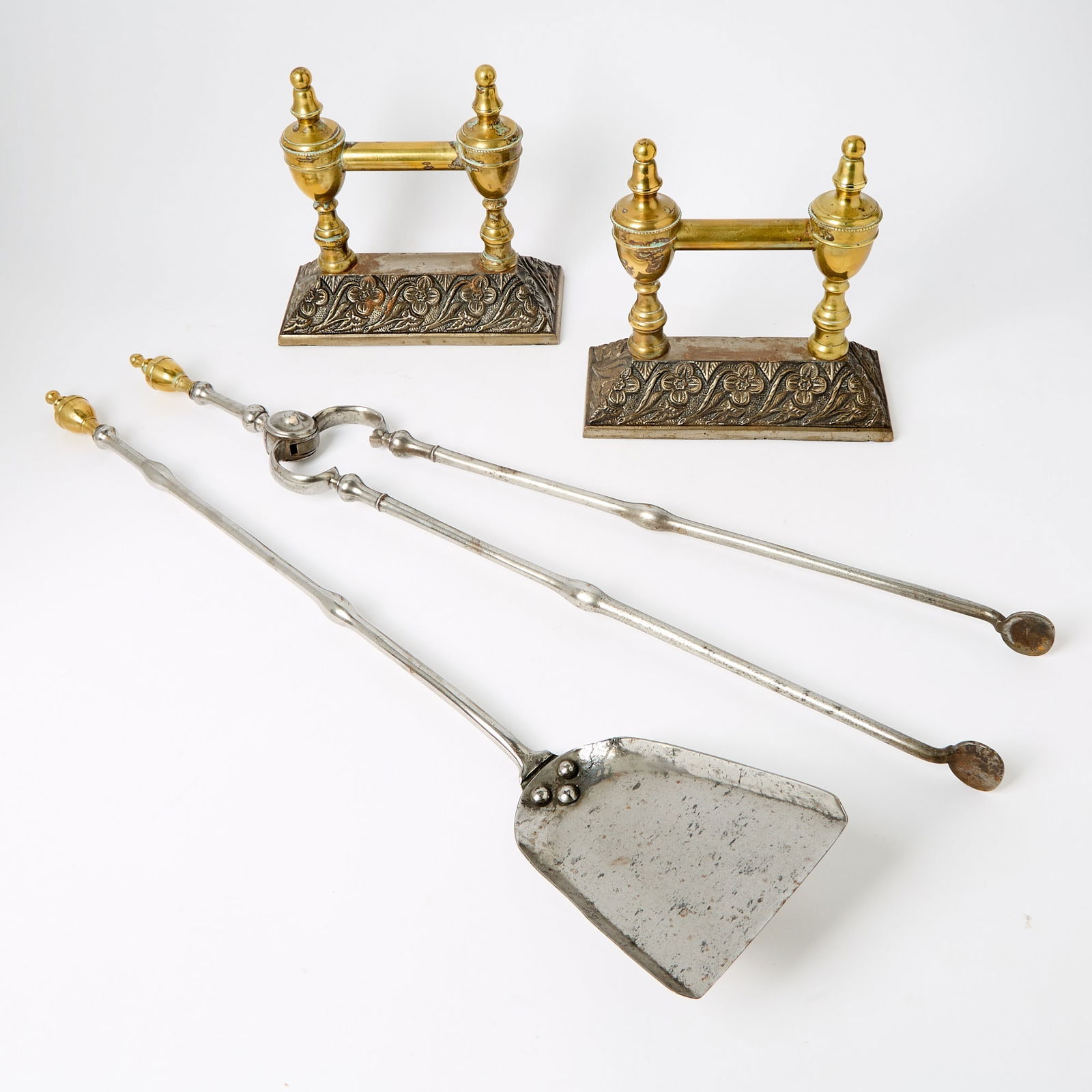 Group of George III Style Bronze and Steel Andirons and Fire Tools: Late 19th/early 20th century Each double urn finial andiron on a flaring rectangular base. height 9 inches (23 cm), width 8 3/4 inches (22.2 cm), depth 3 3/4 inches (9.5 cm), together with two tools l