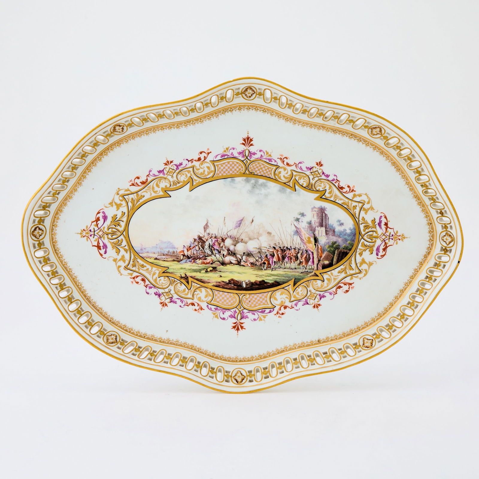 Meissen Marcolini Reticulated Porcelain Oval Tray: Late 18th Century The center gilt-heightened and decorated in colors depicting a battle scene within an openworked gallery. Crossed sword marks in underglaze blue above a star. Width 16 3/4 inches (42