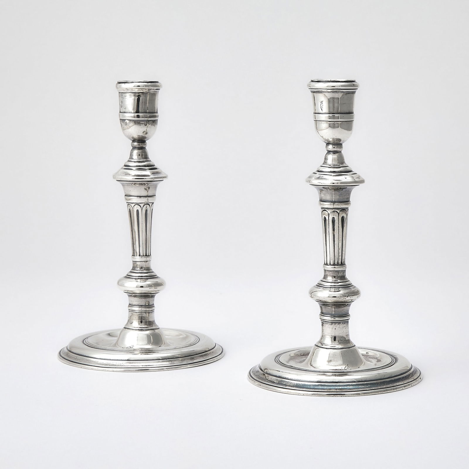 Pair of Irish Georgian Sterling Silver Candlesticks: 18th Century Each with a knopped stem on a dished circular base. Height 7 1/4 inches (18.2 cm), total approximately 24 ounces.