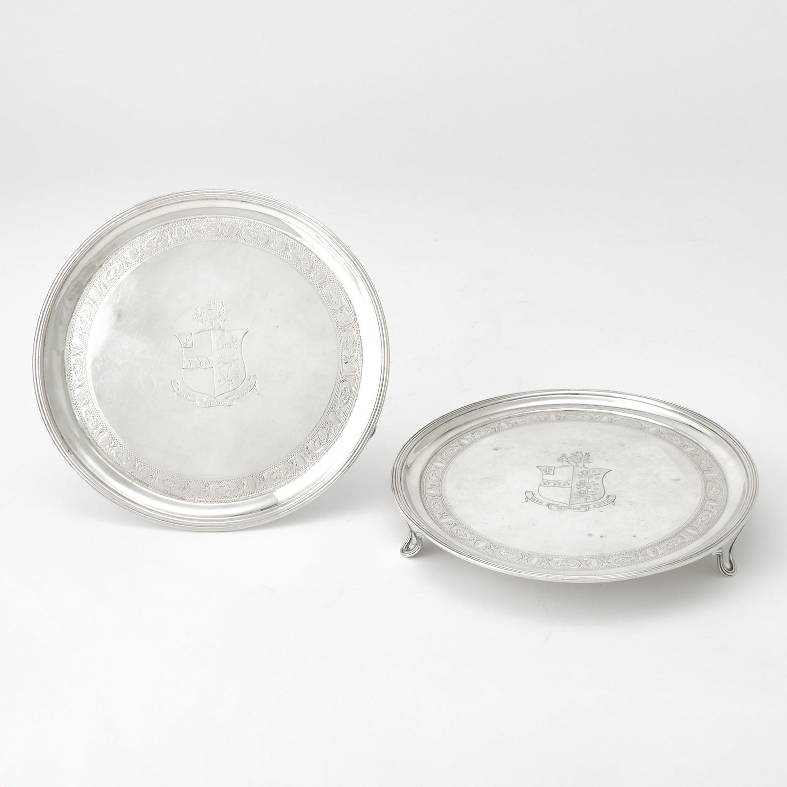 Pair of George III Sterling Silver Salvers: Thomas Harper, London, 1792 Each circular with reeded border, raised on three bracket feet. Diameter 7 1/8 inches (18 cm), total approximately 16 ounces. Generally good condition overall; centers eng