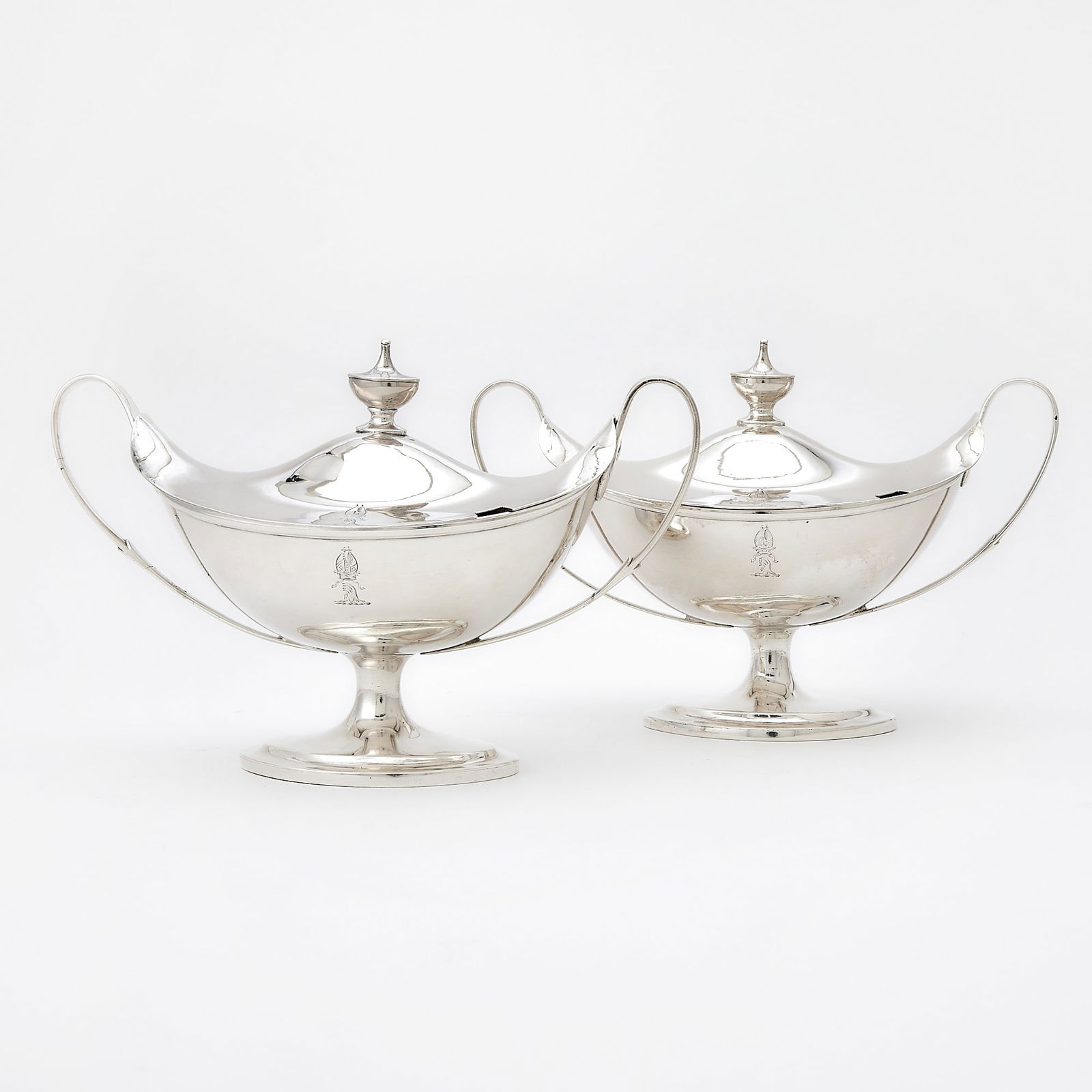 Pair of Irish George III Sterling Silver Covered Sauce Tureens: Thomas Jones, Dublin, 1793/1795 Each oval with molded rim and upswept loop handles, the covers with urn-form finials. Length over handles 9 1/2 inches (24 cm), total approximately 37 ounces. Generall