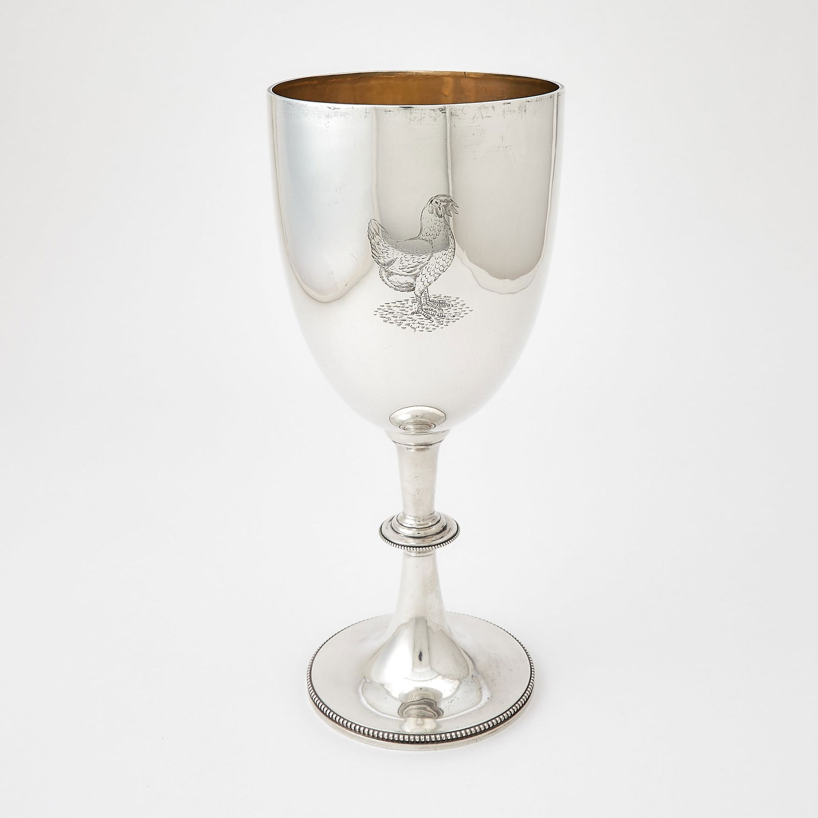 Victorian Sterling Silver Oversized Goblet: Lambert & Co., London, 1894 With knopped stem with beaded rim. Height 12 1/4 inches (31 cm), approximately 22 ounces. Generally good condition overall; engraved with a chicken; the bowl