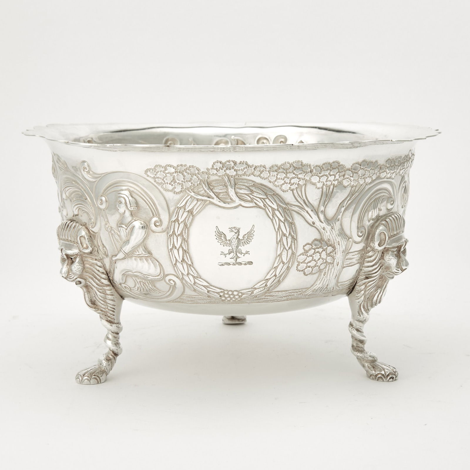 Irish Victorian Sterling Silver Footed Bowl: West & Son, Dublin, 1898 Circular with shaped rim, the body chased with figures, birds, cows and trees, raised on lion mask and paw feet. Height 5 1/2 inches (14 cm), diameter 9 3/4 inches (25