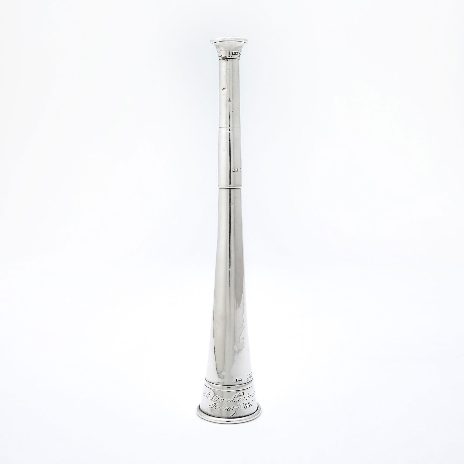 Victorian Sterling Silver Miniature Hunting Horn: Last quarter 19th century Tapering cylindrical form, with presentation inscription dated 1884. Height 9 inches (23 cm), approximately 3 ounces. With small dents and bruises; rubbing to