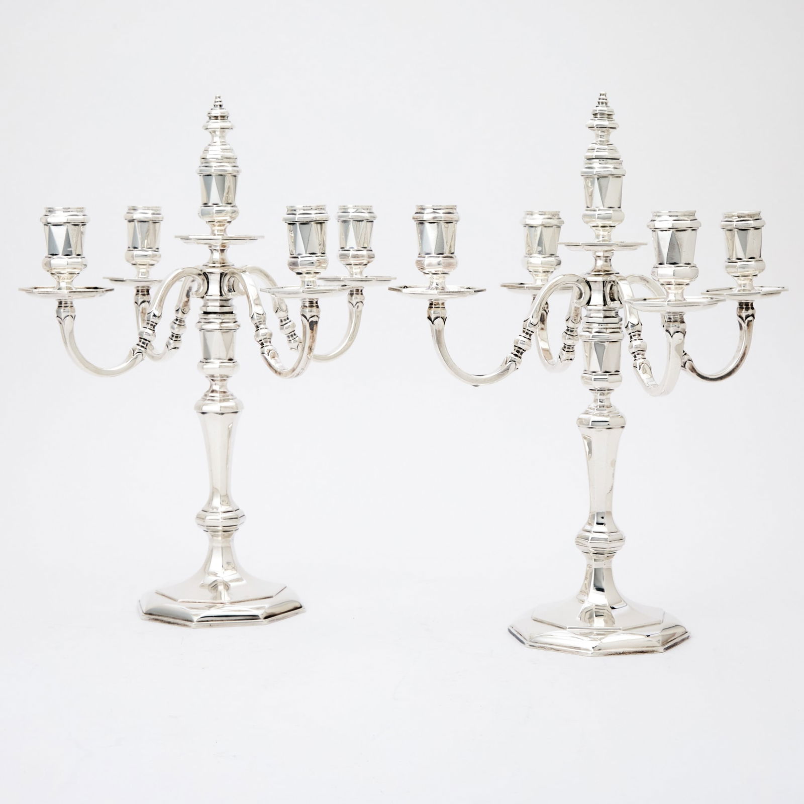 Pair of Tiffany & Co. Sterling Silver Five Light Candelabra: London, 1968 Each facted knopped stem issuing four scrolling branches centering a raised light with removable finial, on an octagonal base. Height 15 1/4 inches (39 cm), total approximately 103 ounces