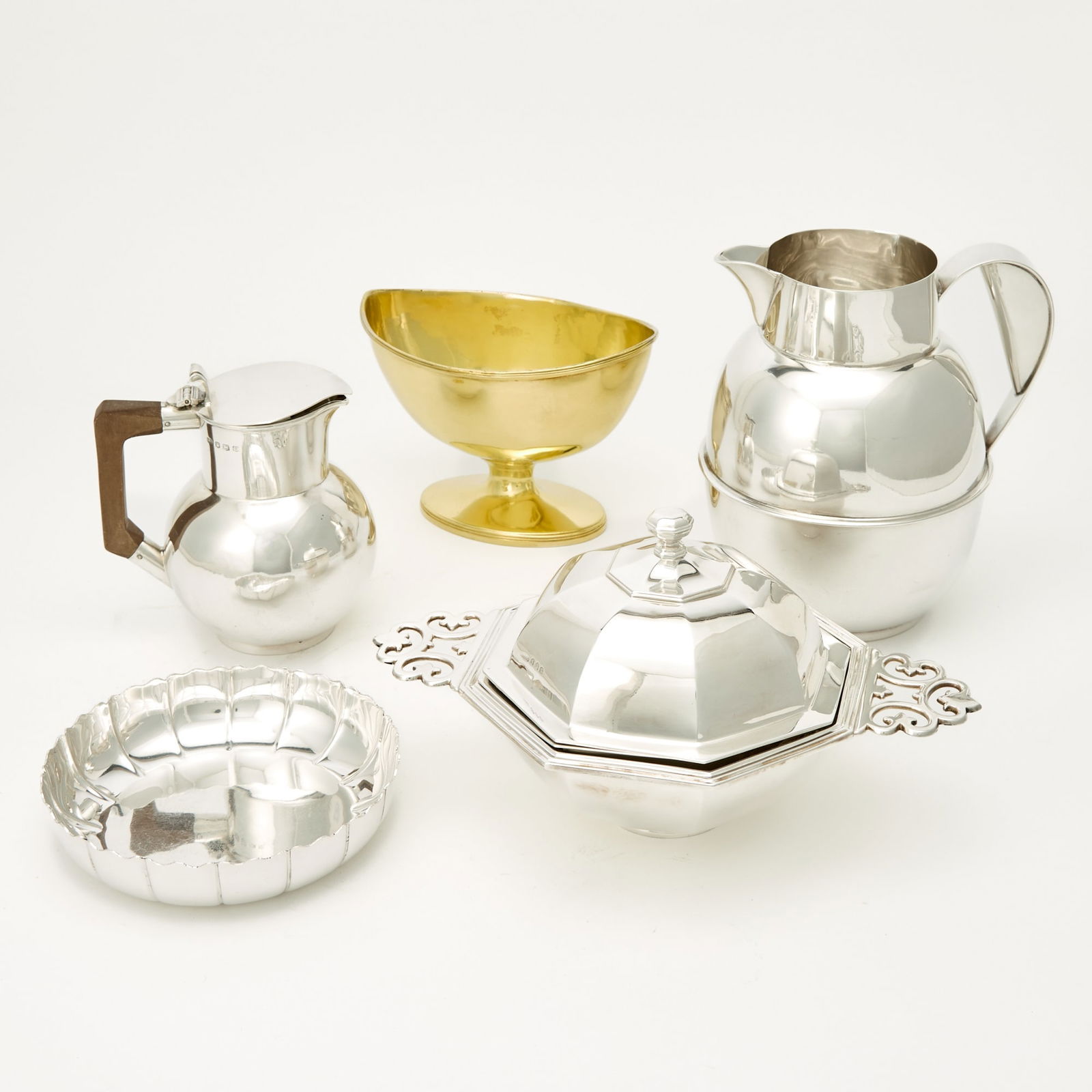 Group of Five Sterling Silver Table Articles: Comprising: George V covered two handled dish, marked Crichton, London, 1930, length over handles 10 1/4 inches (26 cm)George III sugar bowl, marked James Young, London, 1791, length 6 3/4 inches Eliz
