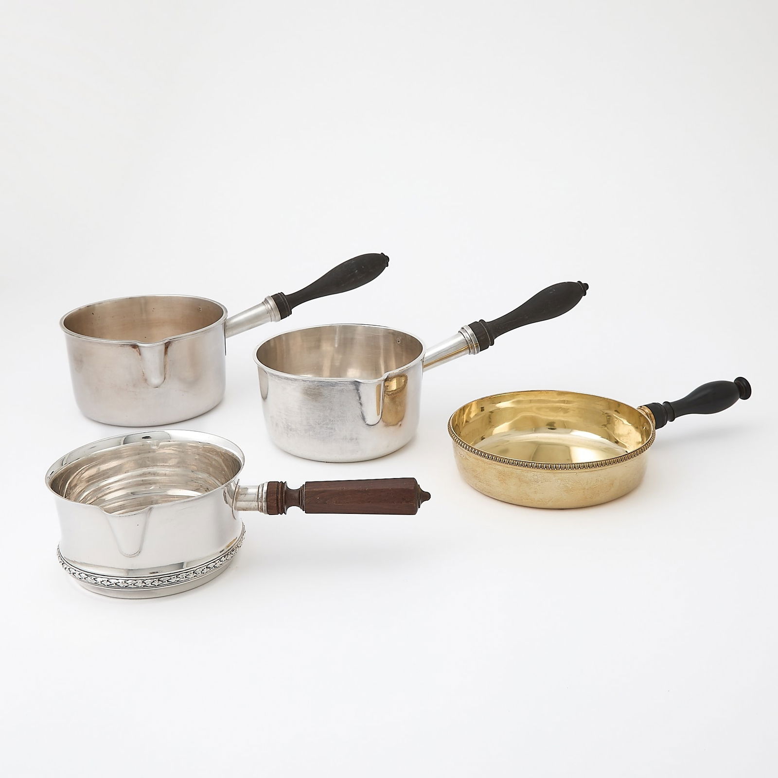 Four French Silver Saucepans: Largest marked Pellerin & Lemoing, Paris, late 19th century, length 10 1/2 inches (26.5 cm)Second largest maker's mark "D Cie with a chalice", length 10 1/4 inches (26 cm)Third largest with husk b