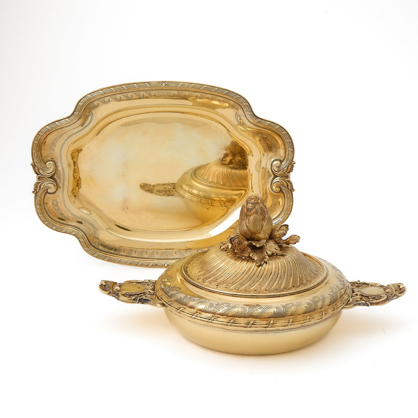 Puiforcat Silver Gilt Covered Ecuelle and Tray: 20th Century In the Louis XVI style, the ecuelle with cast flat handles, the cover with part spiral fluting, with artichoke form finial; the tray shaped rectangular with tied reeded border. Length of