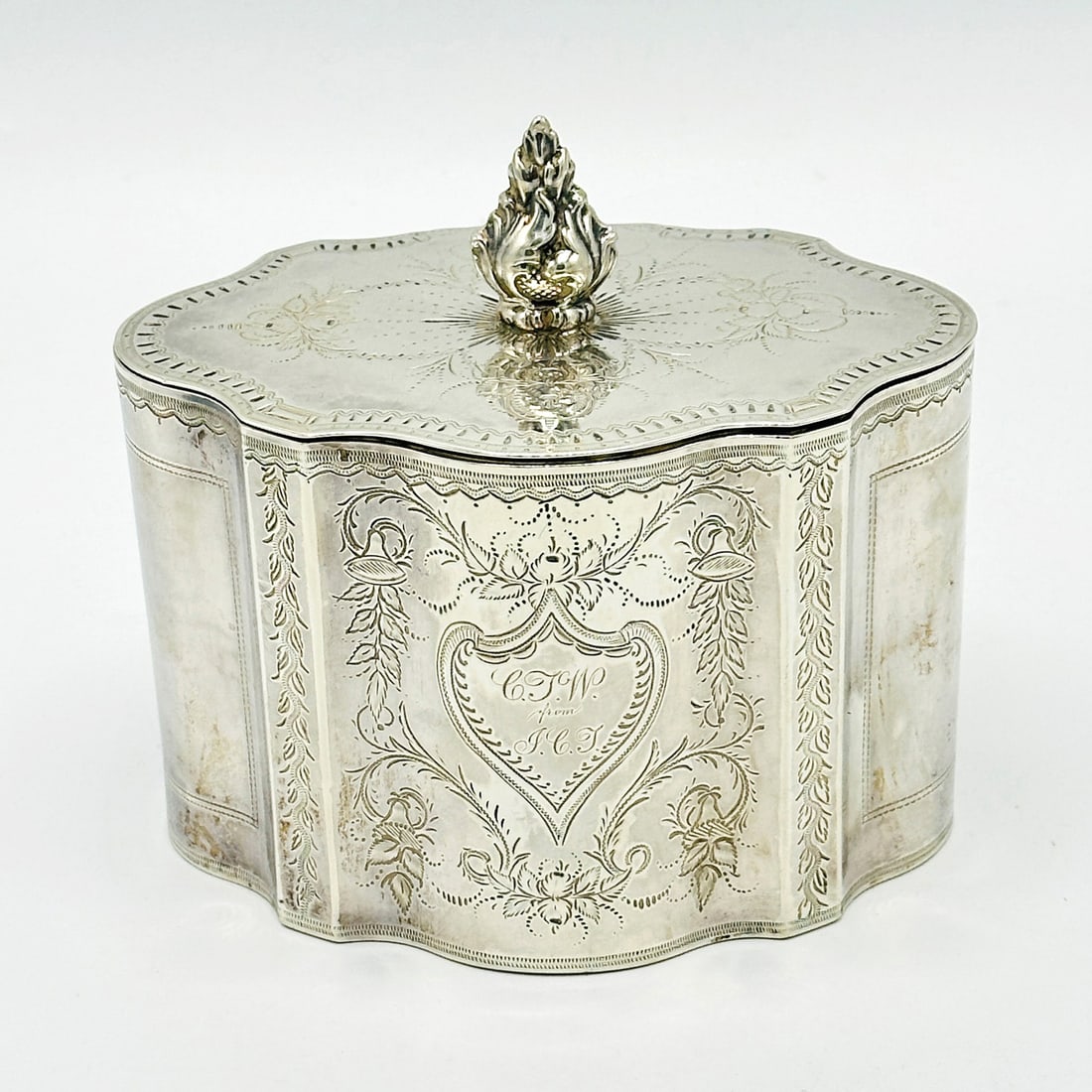 American Silver Tea Caddy: William Gale & Son, NY, 1860sShaped oval with engraved foliage, the hinged cover with flame-form finial. Height over finial 4 3/4 inches, approximately 9 ounces.