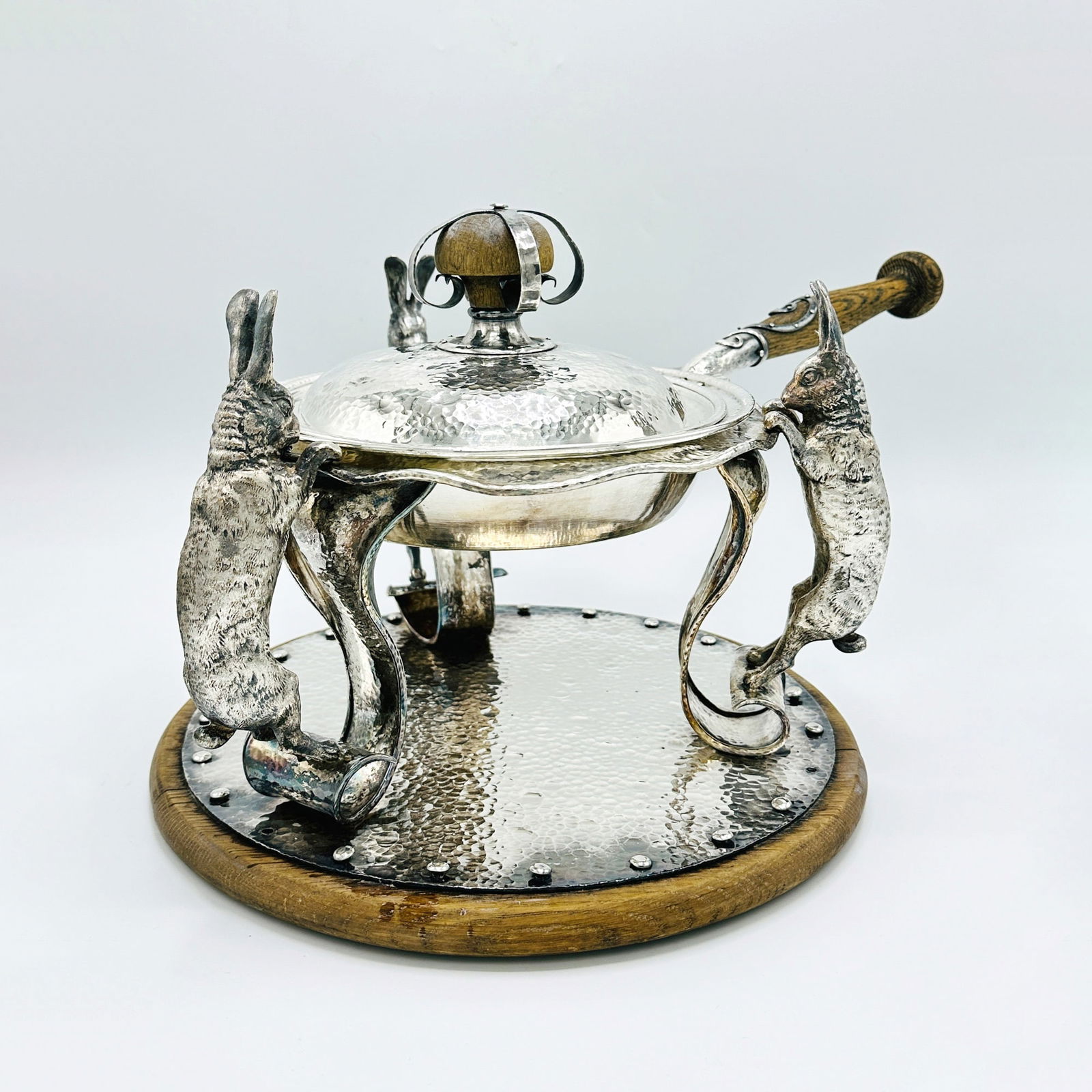 Joseph Heinrichs Silver Plated Rabbit Covered Chafing Dish and Stand: Circa 1904Circular, the stand with scrolling supports and figures of rabbits, on a circular base. Height 10 1/2 inches, length over handle 20 inches.