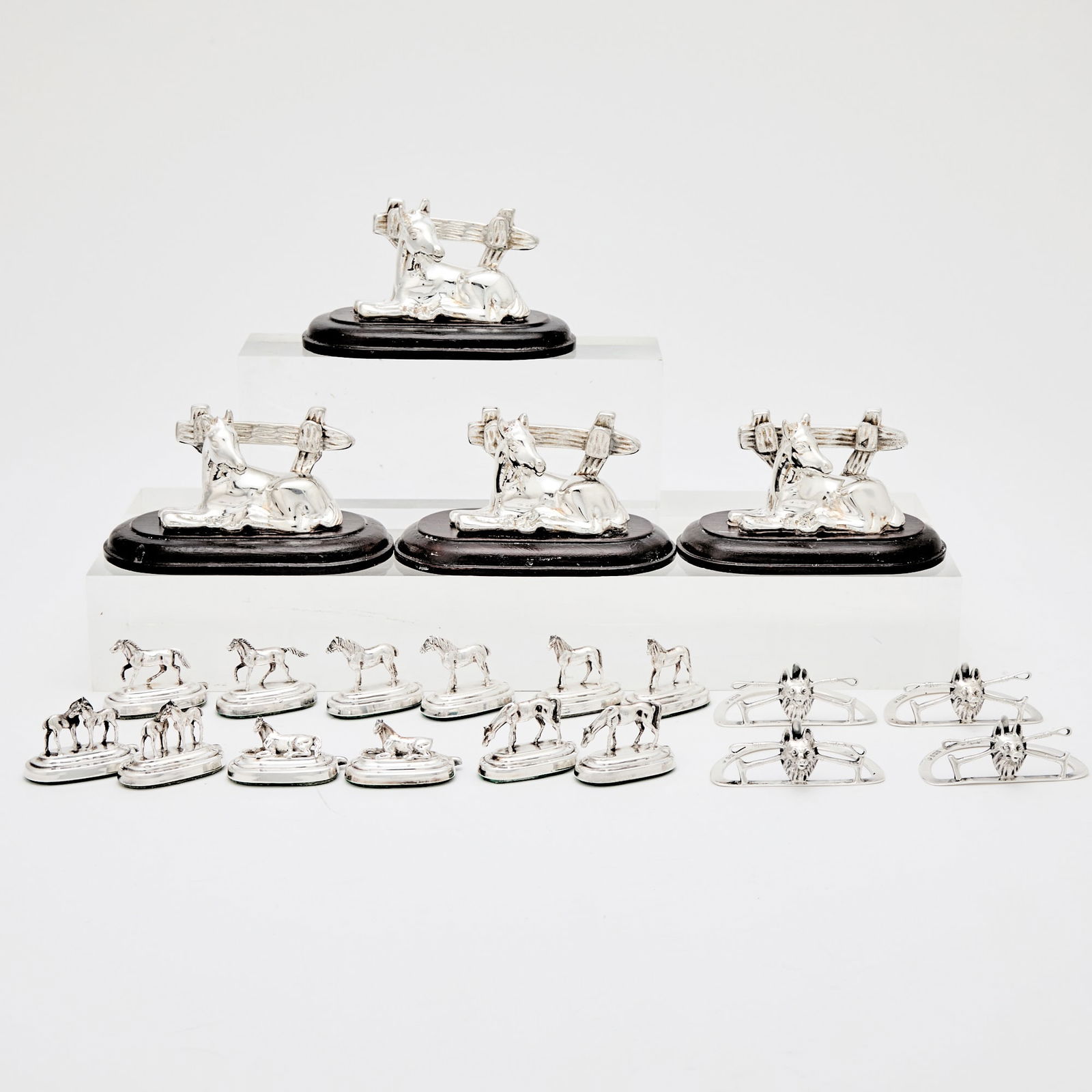 Group of Equestrian-Themed Silver and Silver Plated Menu and Place Card Holders: Comprising four Edward VII sterling silver fox-form place card holders, Birmingham, 1907, in a fitted case, twelve Continental silver place card holders modeled as seated horses, and four silver-plate