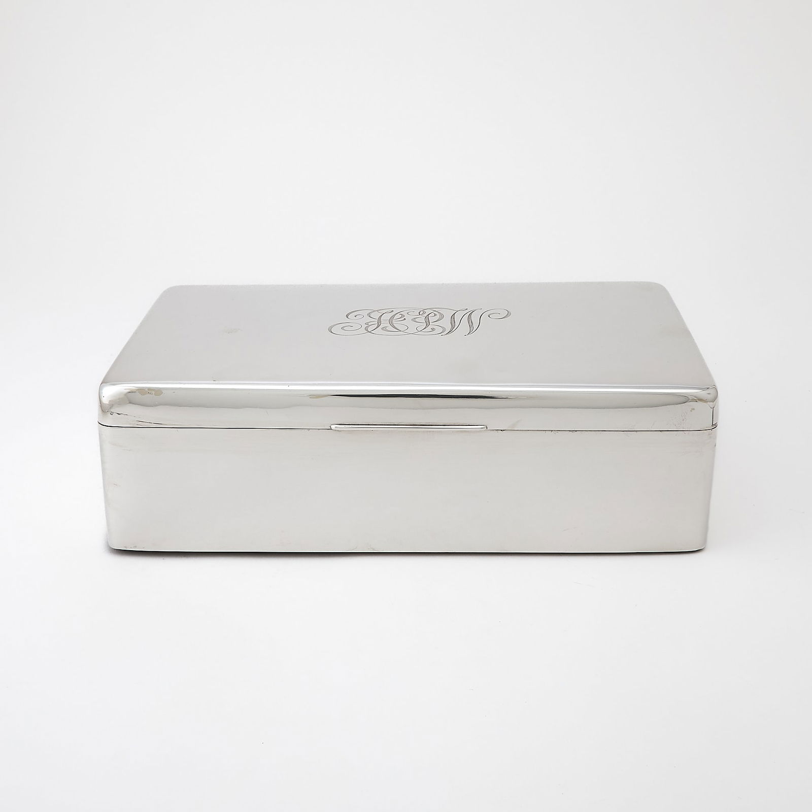 Victorian Sterling Silver Cigar Box, engraved for H.P. Whitney: Birmingham, 1896 Rectangular, wood lined, the cover engraved H.P.W. on side and cover. Length 12 inches, weighted. Wear to the marks and and a few bruises to the body.