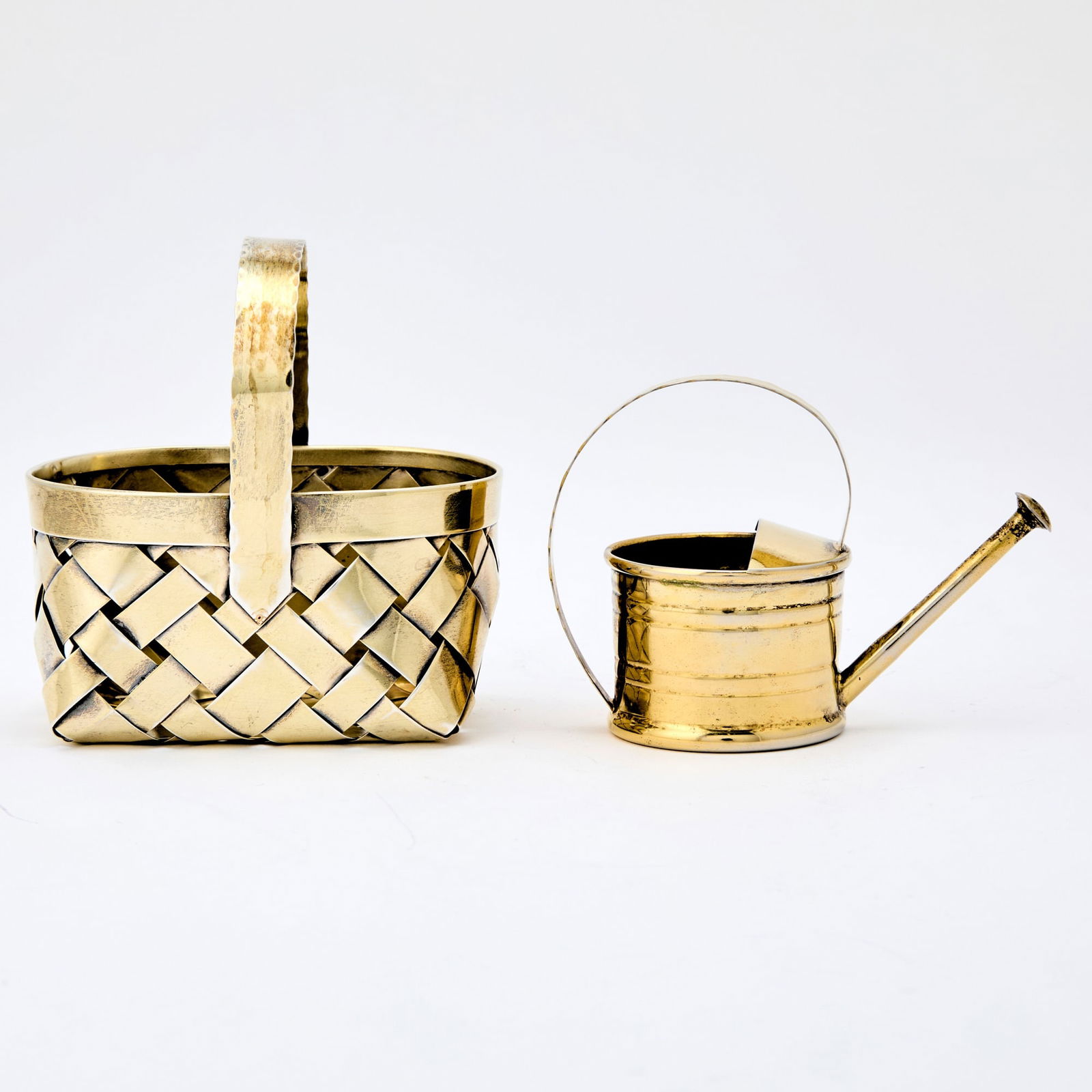 Cartier Sterling Silver Gilt Miniature Watering Can and Basket: 20th Century Rectangular basket and circular watering can, each marked on base. Length of basket 4 inches; total approximately 5 ounces. Baseket with some where to the gilding.