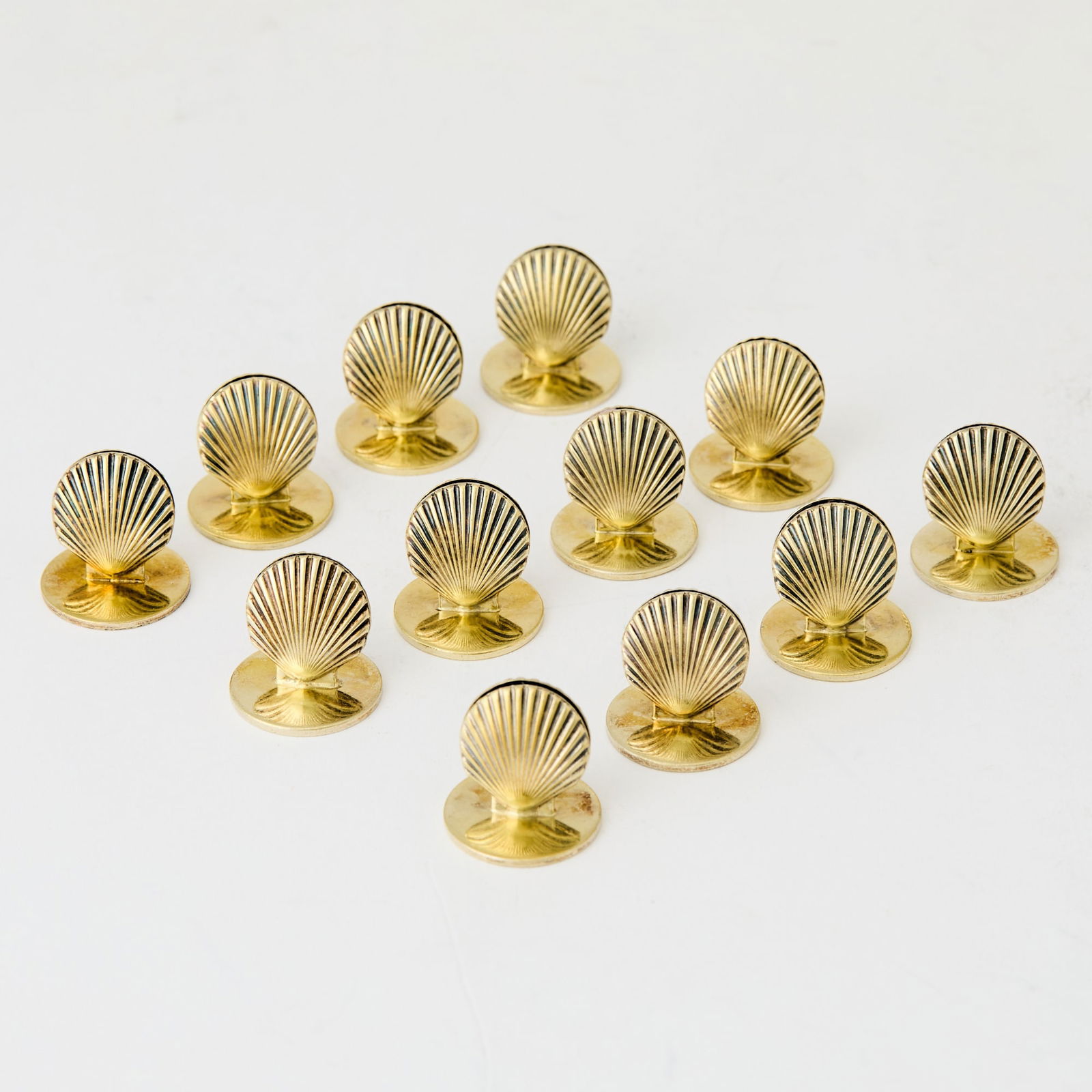 Set of Twelve Tiffany & Co. Sterling Silver-Gilt Shell-Form Place Card Holders: 20th Century Marked on base. Height 3/4 inches, total approximately 3 ounces.