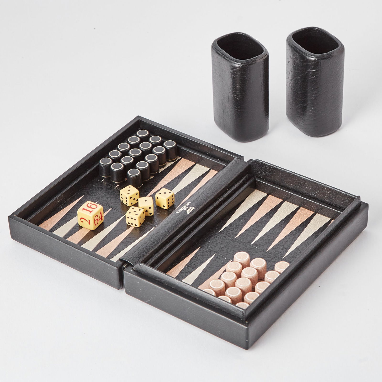 T. Anthony Ltd. Monogrammed Leather Travel Backgammon Set: 20th Century Monogrammed THE WHITNEYS. Open: 7 inches x 9 inches.