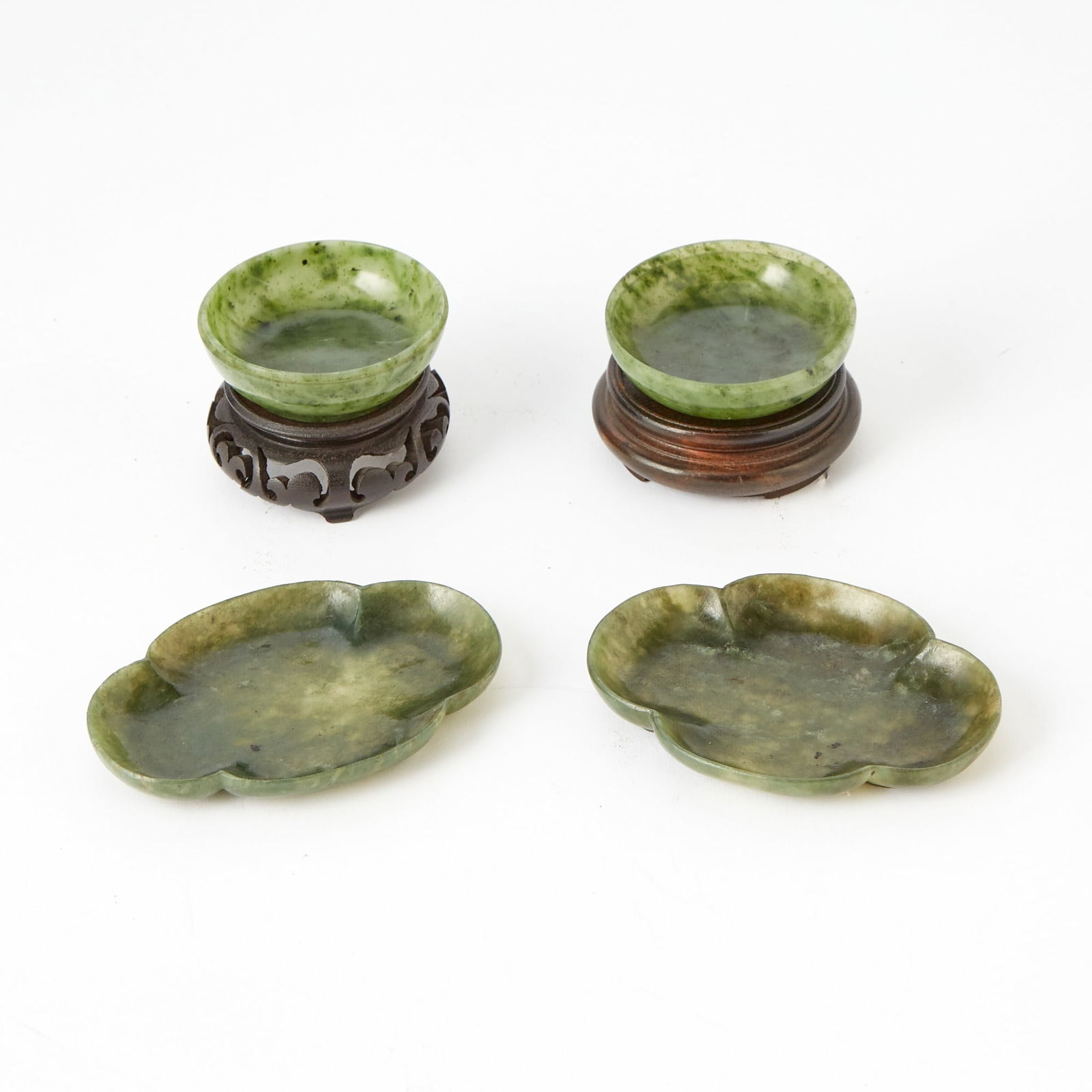 A Chinese Mossy Jade Domed Box: 20th Century Together with a pair of green hardstone quatrefoil dishes. Diameter of box 3 inches