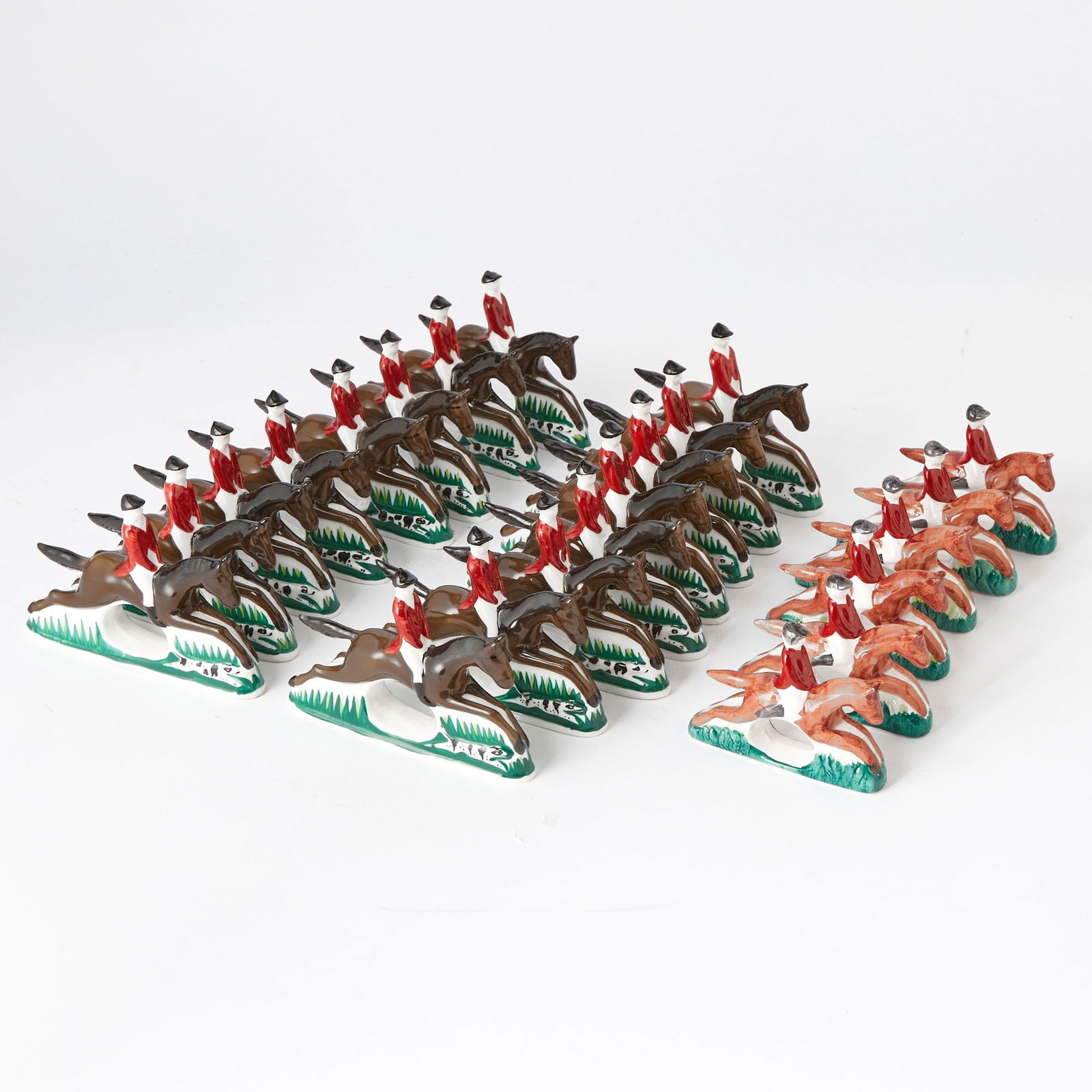 Two Sets of Painted Porcelain "Huntsman" Napkin Rings: 20th Century Comprising a set of sixteen, labeled BONE CHINA PIA PHILIPPINES, height 4 inches, length 5 3/4 inches; and a set of six smaller examples, labeled KNOBLER TAIWAN. Another set of sixteen Pi