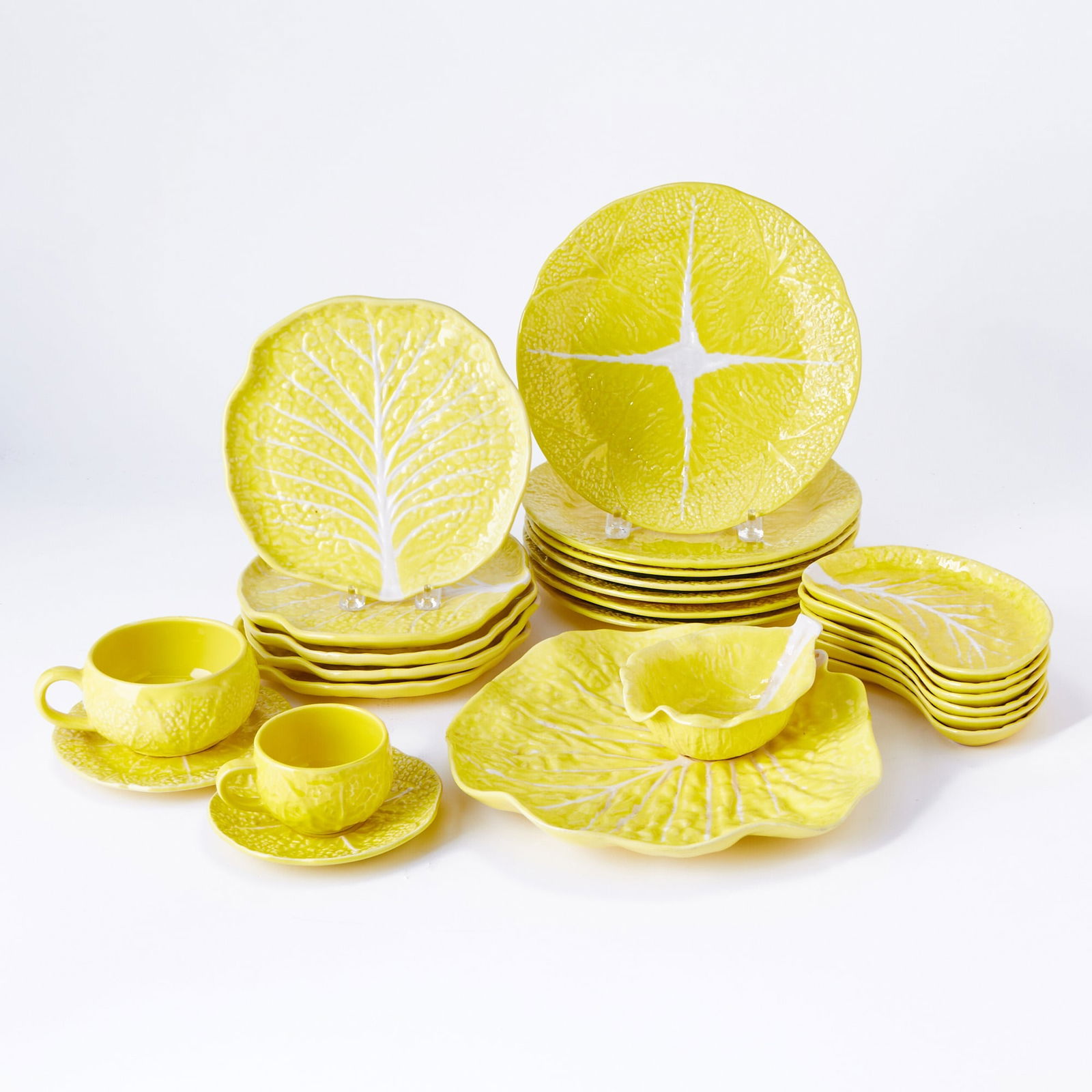 Secla Portugal Yellow Glazed Ceramic "Cabbage" Pattern Partial Dinner Service: 20th Century Comprising: Twelve large dinner plates, diameter 10 7/8 inches Eight salad plates Eight crescent shaped salad bowls Ten leaf form bowls Twelve dessert plates Seven small bowls with se
