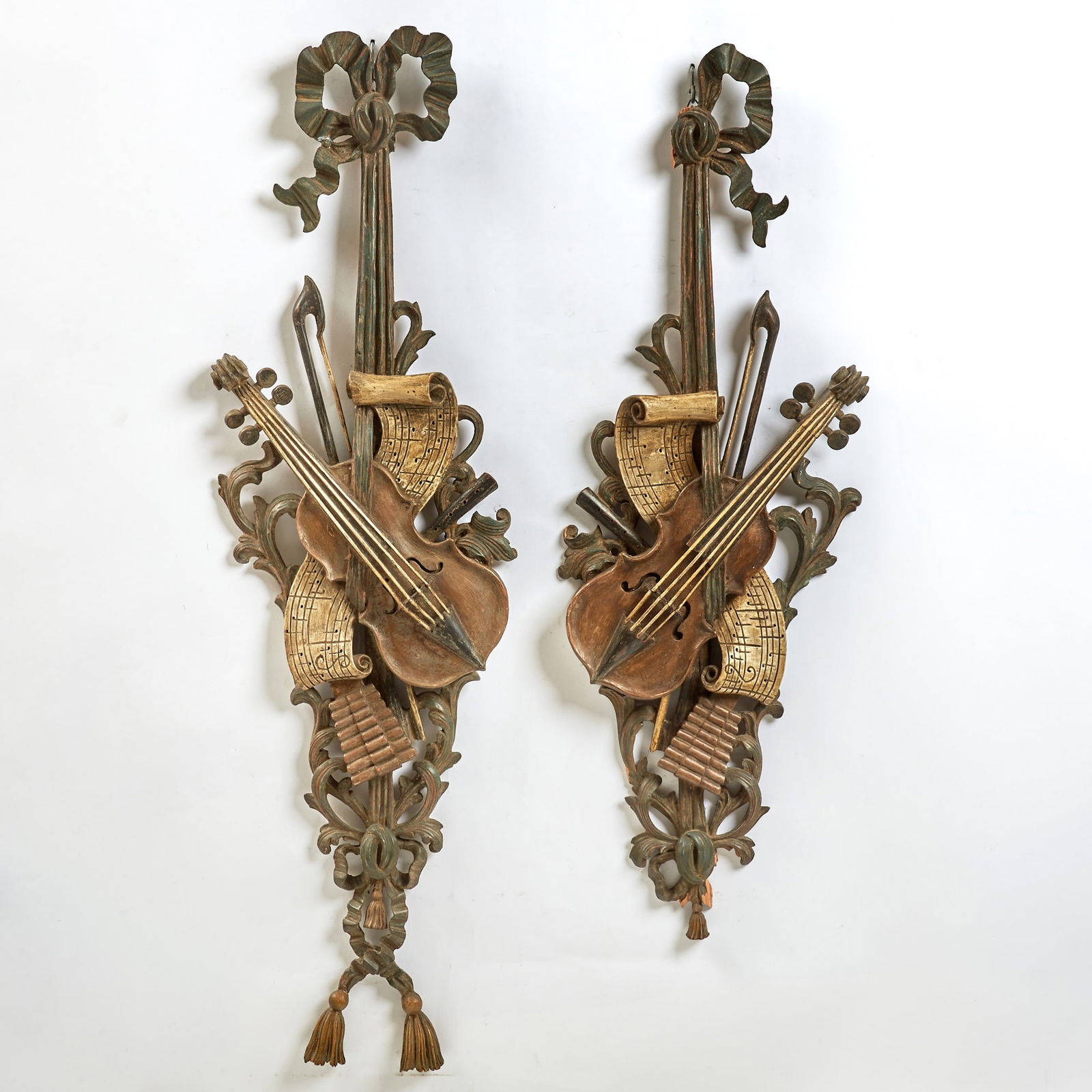 Pair of Italian Neoclassical Style Carved Wood Wall Appliques with Musical Trophies: Mid-20th century Height of taller 42 inches, width 12 inches. Formerly in the Whitney residence, New York City, illustrated in “Tradition and Intimacy: The Cornelius Vanderbilt Whitneys in New