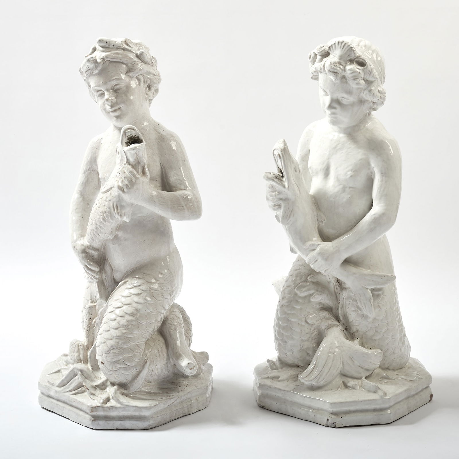 Pair of Bavent Glazed Faience Figures of Sea Nymphs: Normandy, France, 20th century Height 32 inches, width 14 inches, depth 14 inches.