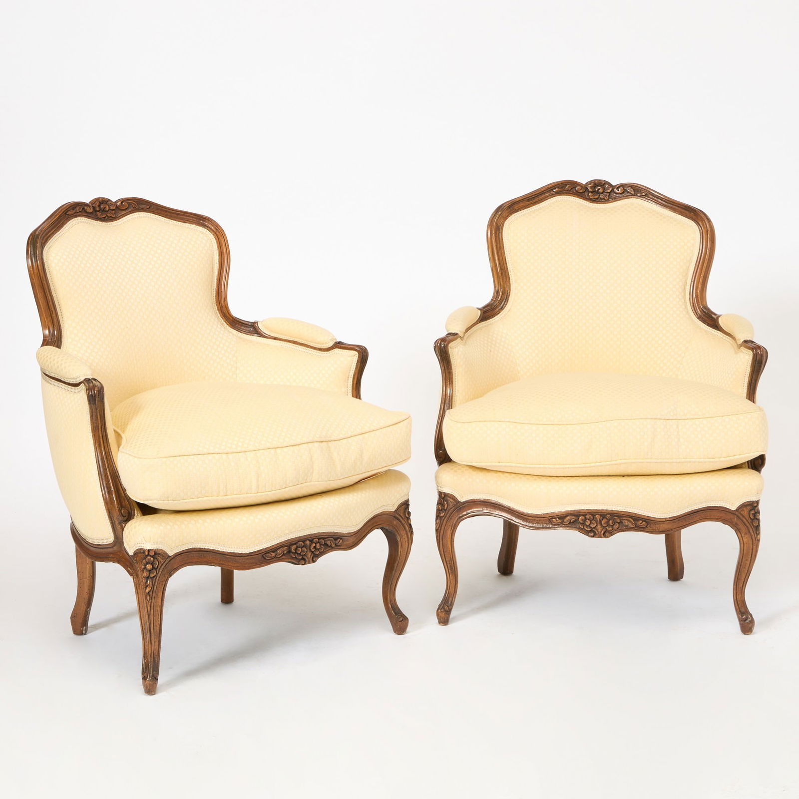 Pair of Louis XV Style Upholstered Fruitwood Bergères: Mid to late 20th century Height 33 inches, width 26 inches, depth 22 inches.