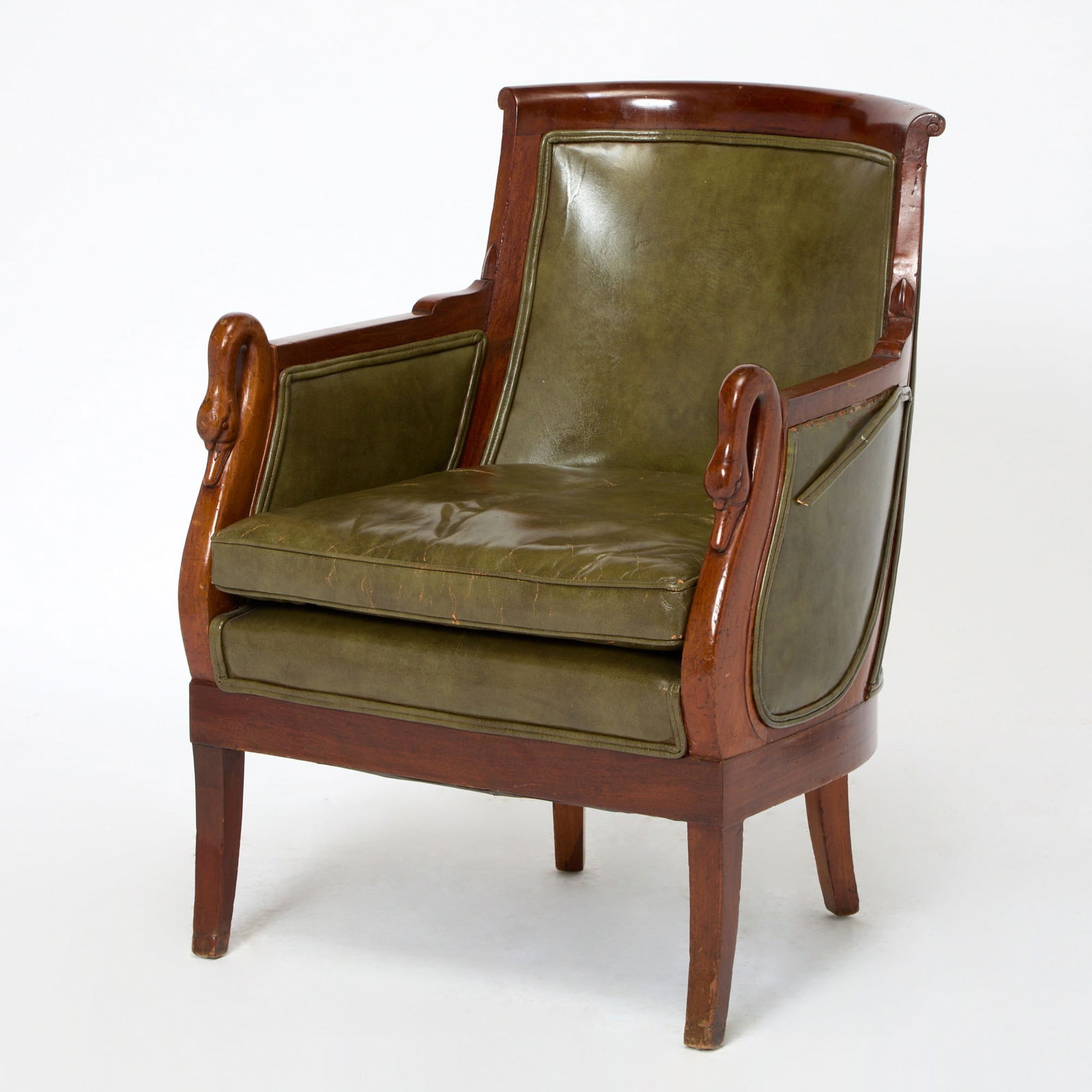 Directoire Leather Upholstered Mahogany Swan Bergère: Early 19th century Upholstered in green leather. Height 34 inches, width 26 inches, depth 22 inches. worn and damaged leather,