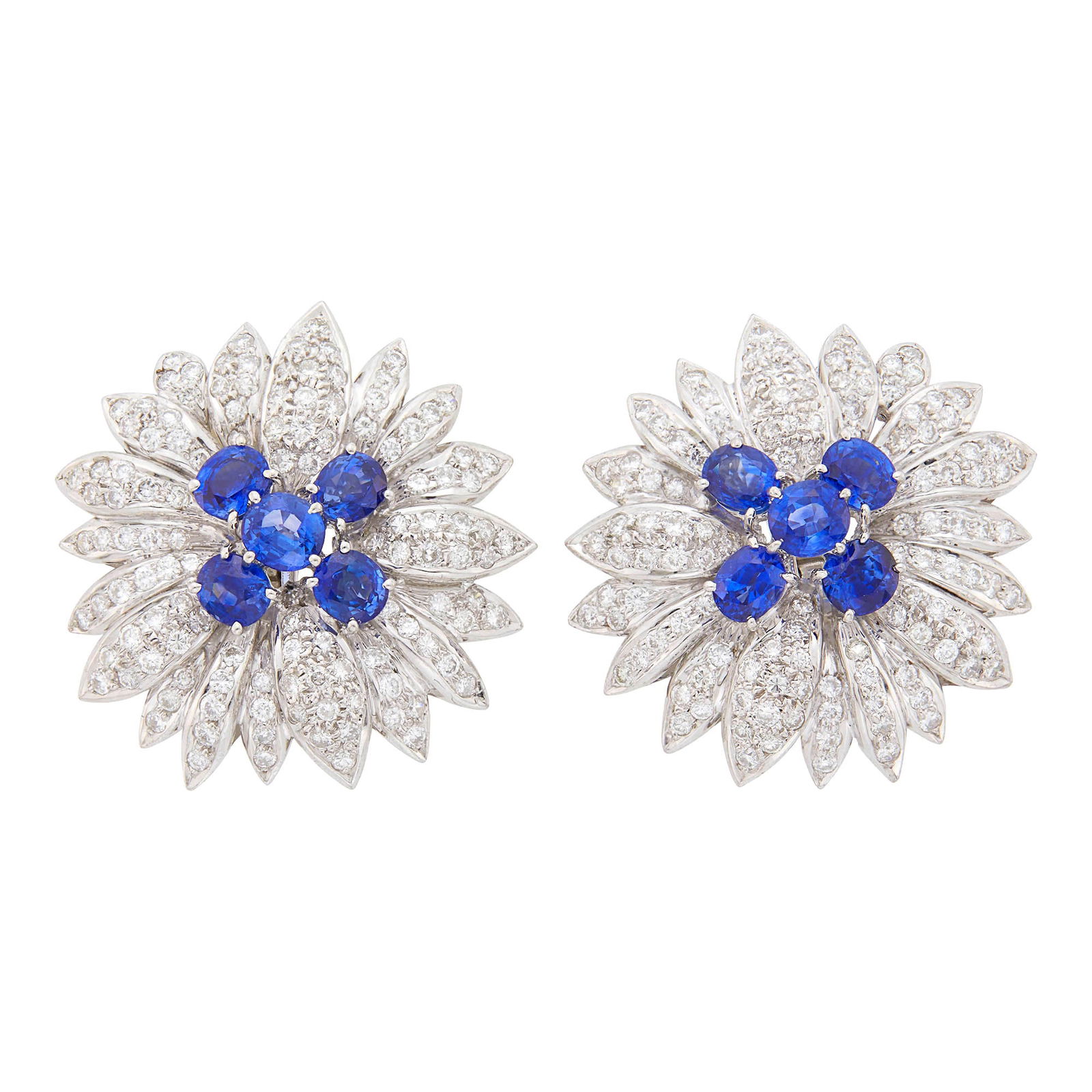 Pair of White Gold, Sapphire and Diamond Flower Earclips: 18 kt., 10 cushion-shaped and oval sapphires ap. 6.25 cts., 240 round diamonds ap. 6.00 cts., ap. 24.4 dwts. Sapphires: bright medium to medium deep blue, cleanish to slightly included, lively. Diamon