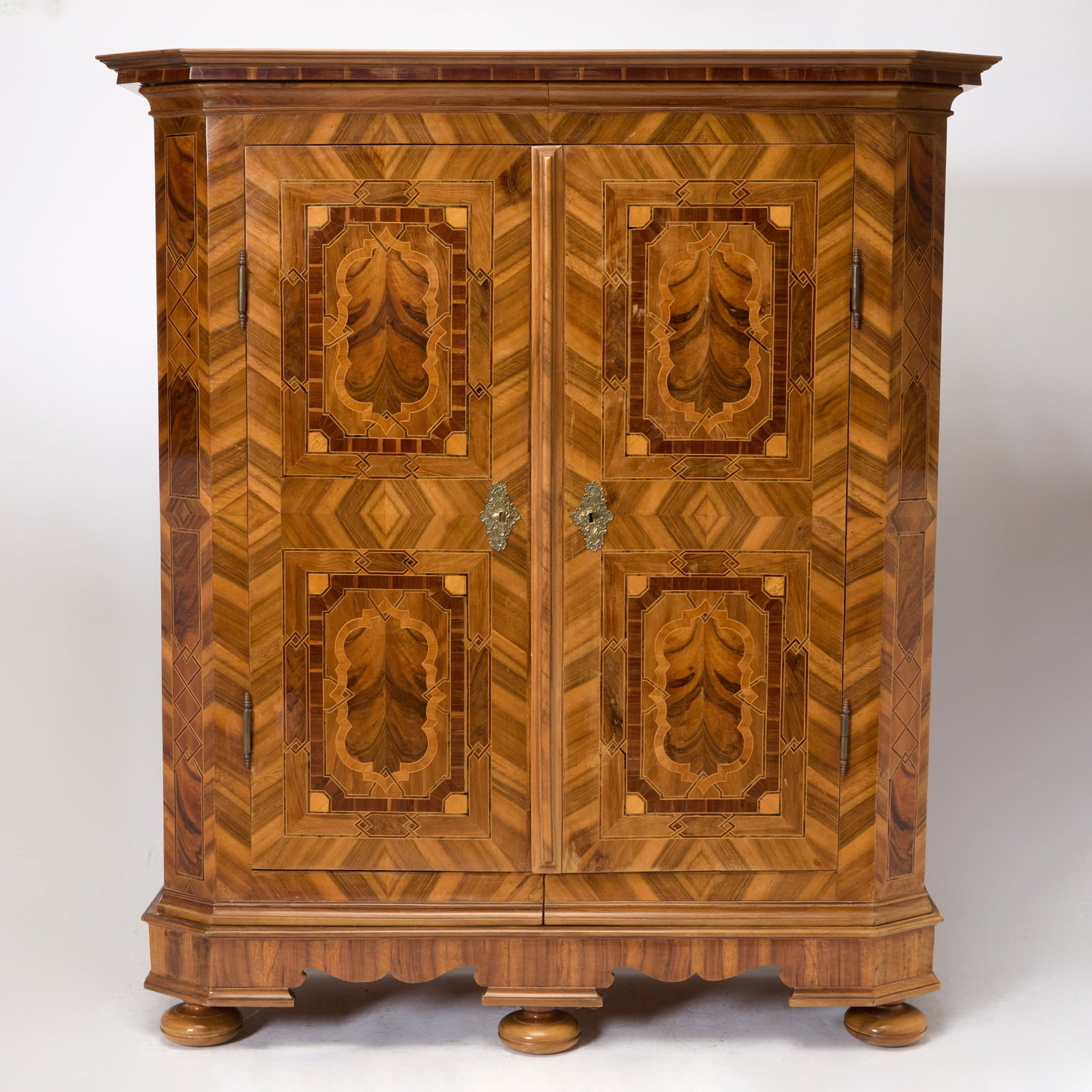 Austrian Baroque Inlaid Walnut Schrank: Tyrolian, mid 18th century Height 7 feet, width 6 feet 2 inches, depth 26 inches.
