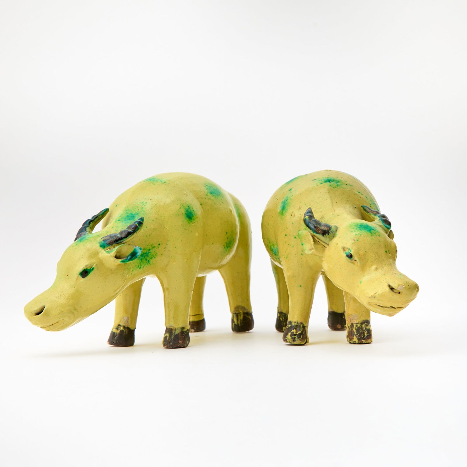 A Pair of Chinese Glazed Porcelain Oxen 19th Century: Each modeled as standing foursquare with heads lowered. (Length 8 3/4 inches)
