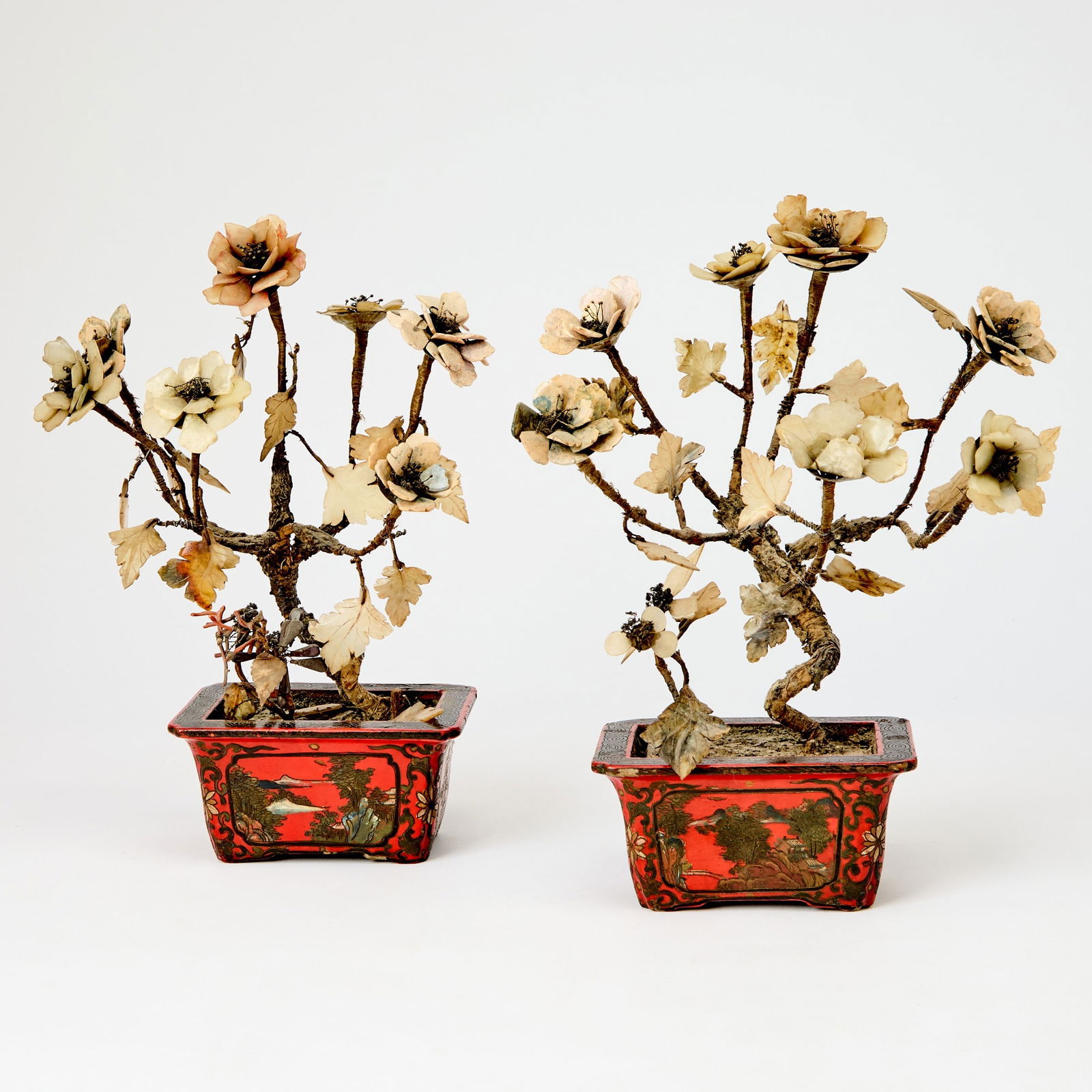 Pair of Chinese Lacquered Planters and Hardstone Flowers Late Qing Dynasty: The planter decorated with landscape scenes and flowering motifs, further issuing blossoms carved from hardstone. (Height 11 1/2 inches)