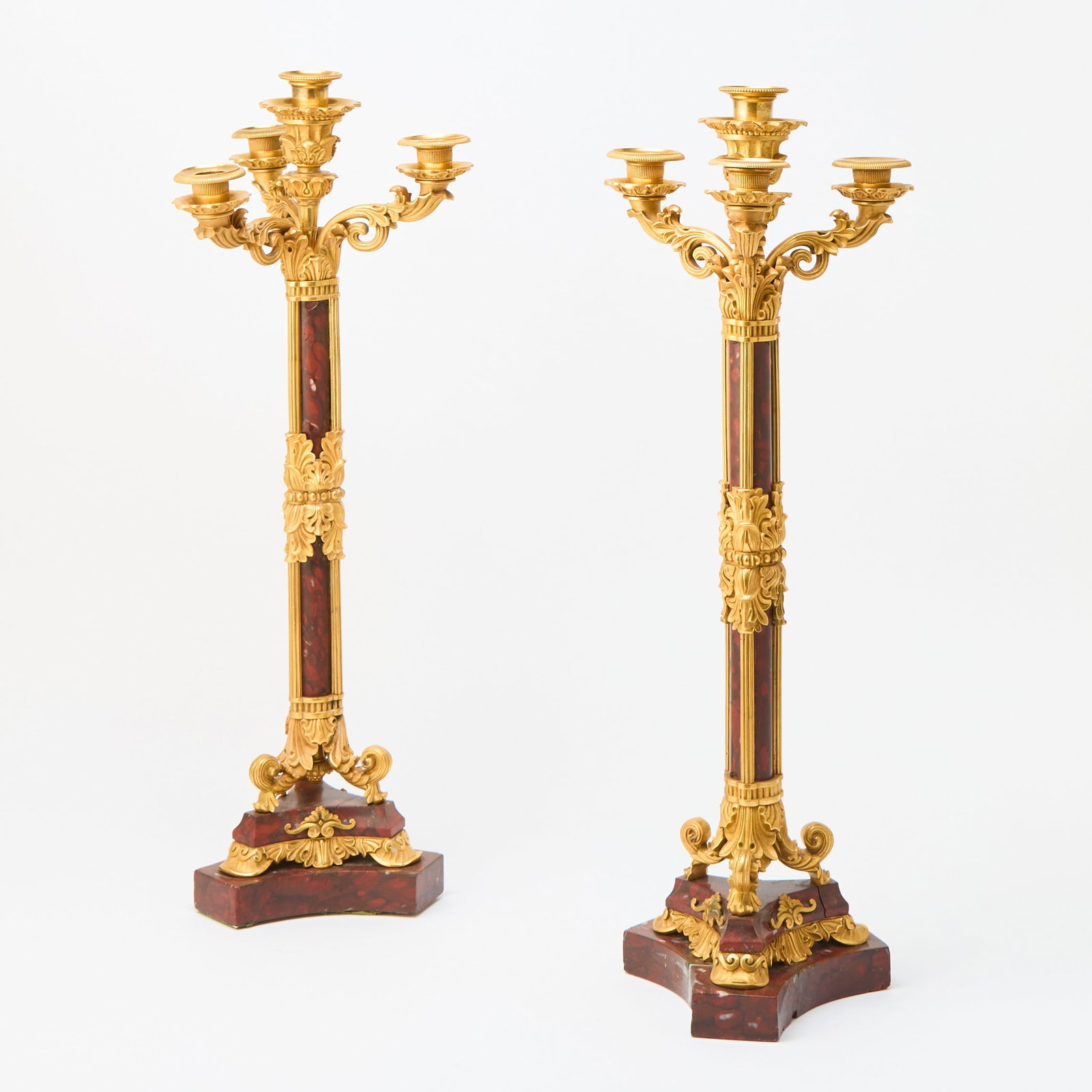 Pair of Napoleon III Gilt-Metal Mounted Rouge Marble Four-Light Candelabra: Height 25 inches, width 9 inches. Metal Mounts: the two center removeable drip cups match each other, however, they are different from the other six matching drip cups; some of the upturned branches