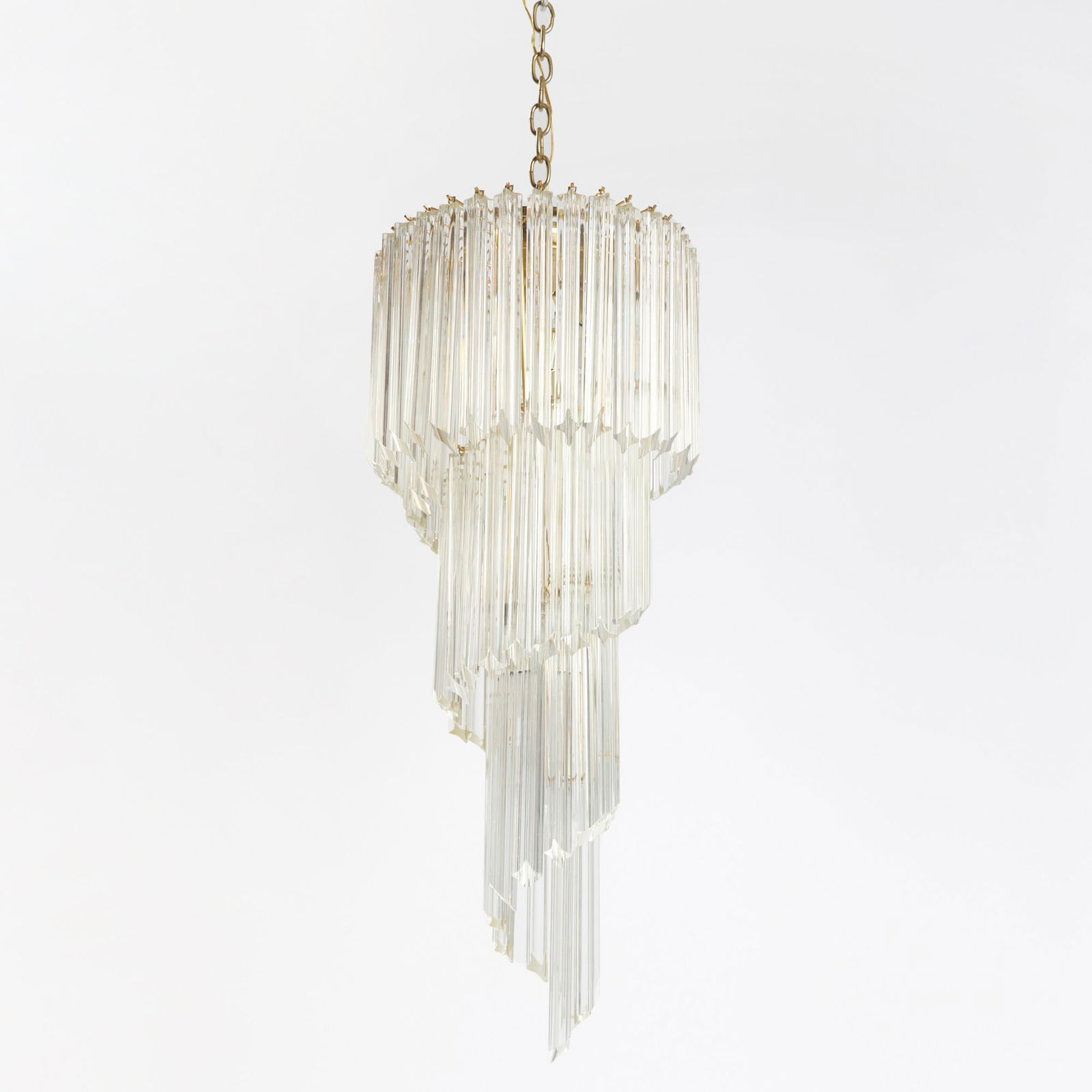 Italian Mid-Century Style Gilt-Metal and Glass Five-Light Chandelier: Of spiral form, hung with approximately eighty colorless prisms. Height 36 inches, diameter 15 inches; length of prism 11 inches.