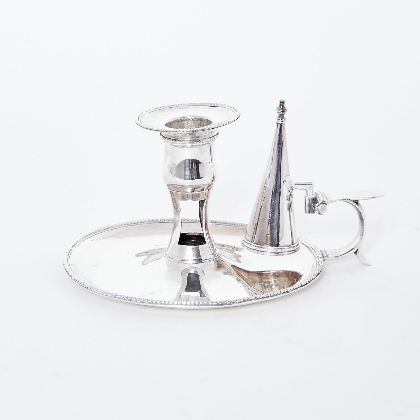 George III Sterling Silver Chamberstick: Hester Bateman, London, 1779 Circular with beaded rim. Length over handle 6 1/4 inches, total approximately 7 ounces. Generally good condition overall; snuffer cap probably 1785